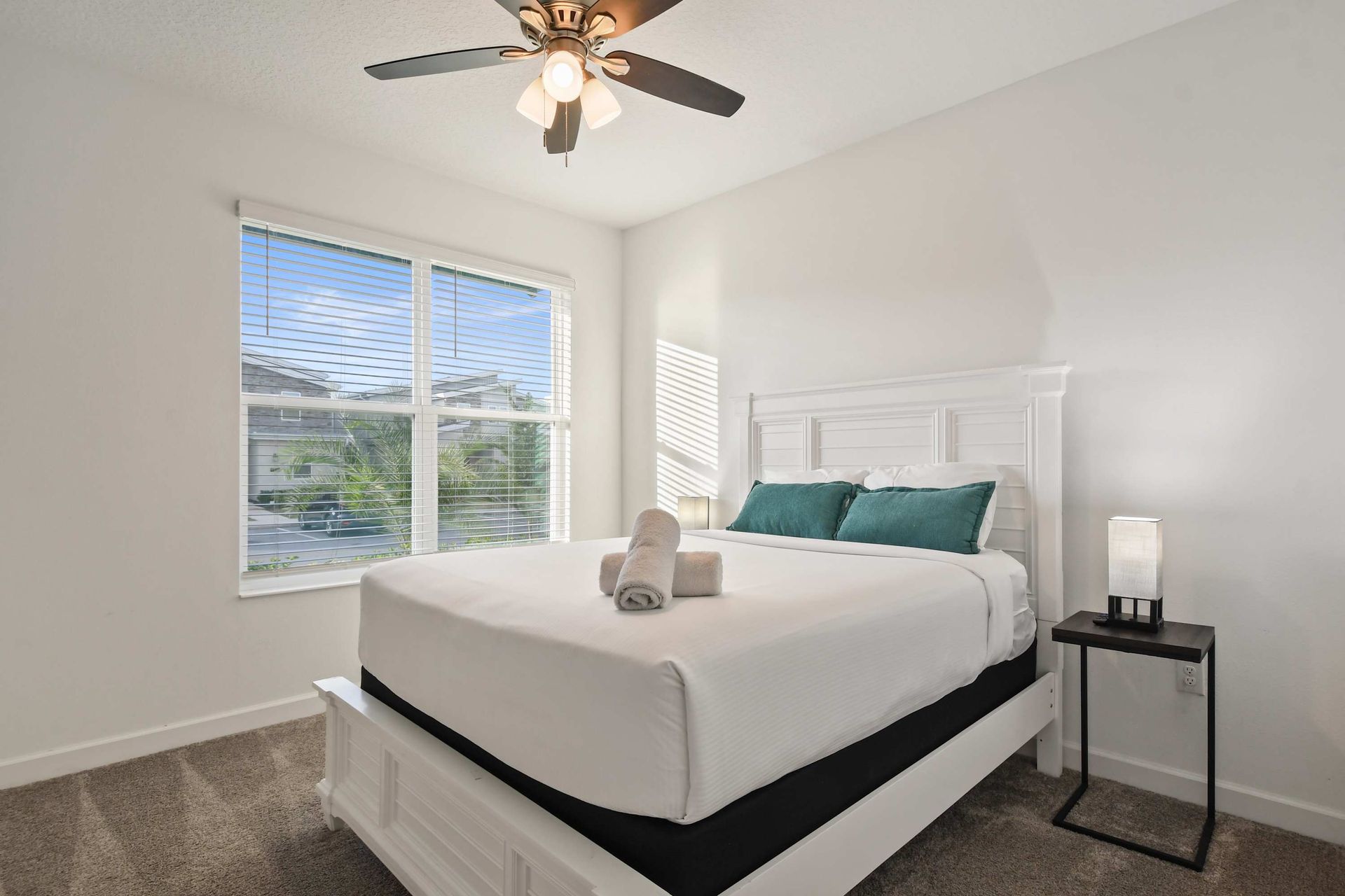 Bright and airy bedroom with a comfy bed, plush pillows, and peaceful views.