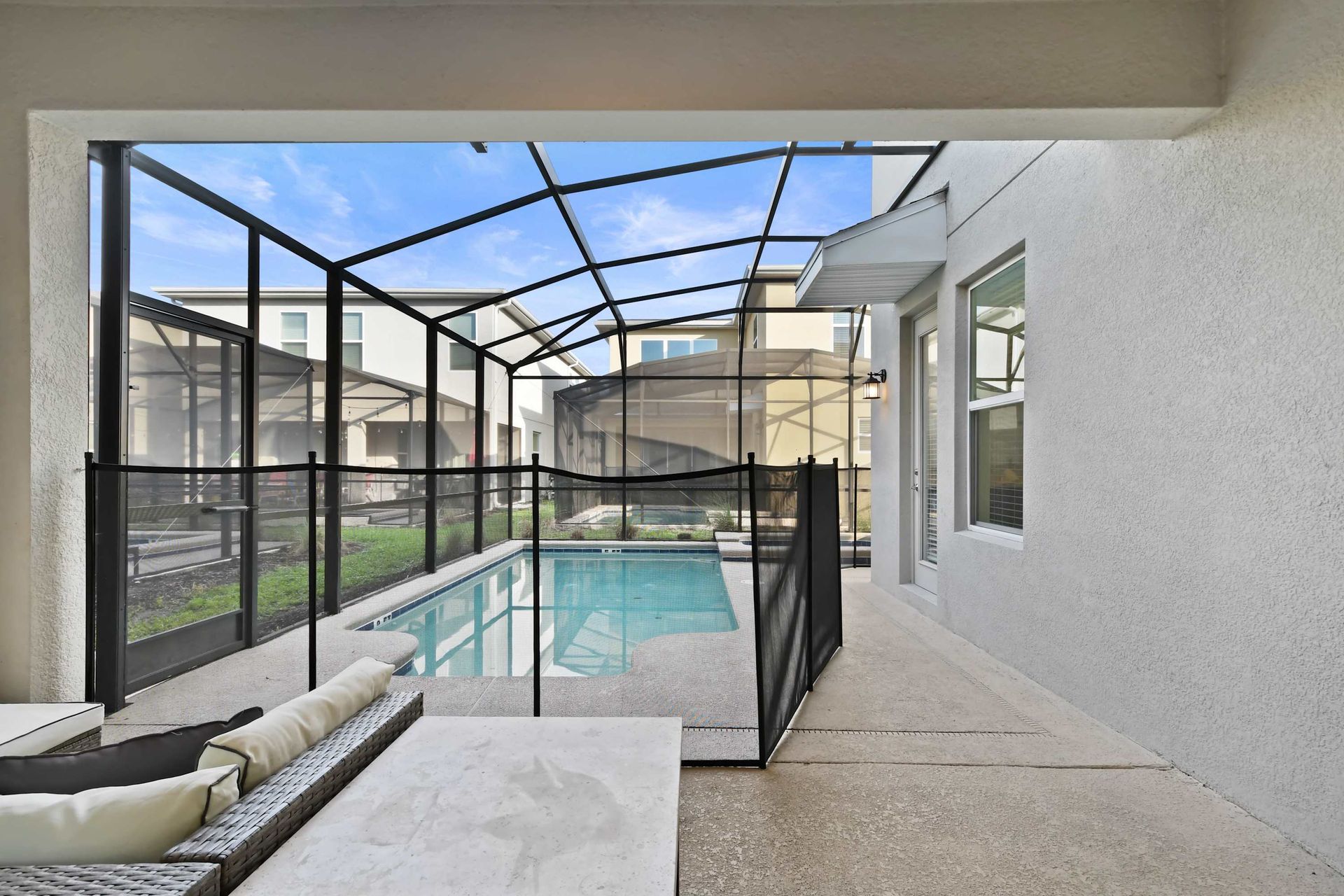 Enjoy your private screened-in pool with lounge seating and sunny skies above.