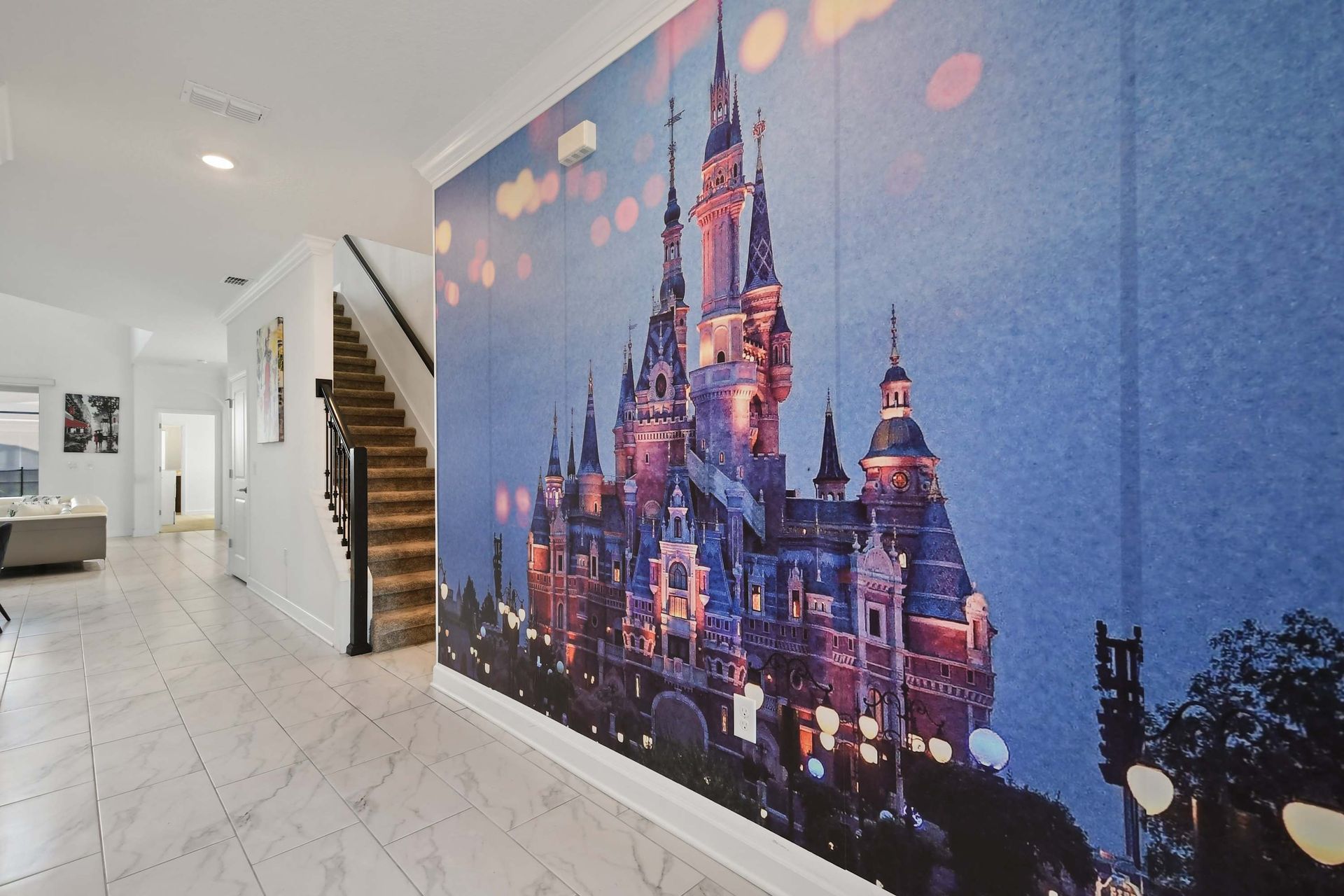 Step into the magic with this enchanting castle mural near the grand staircase.
