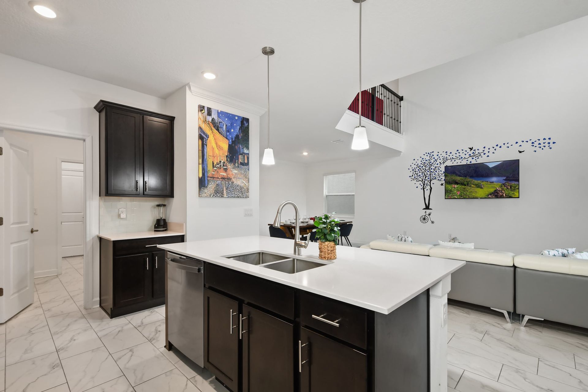 Sleek open-concept kitchen with island seating, pendant lighting, and modern flair.