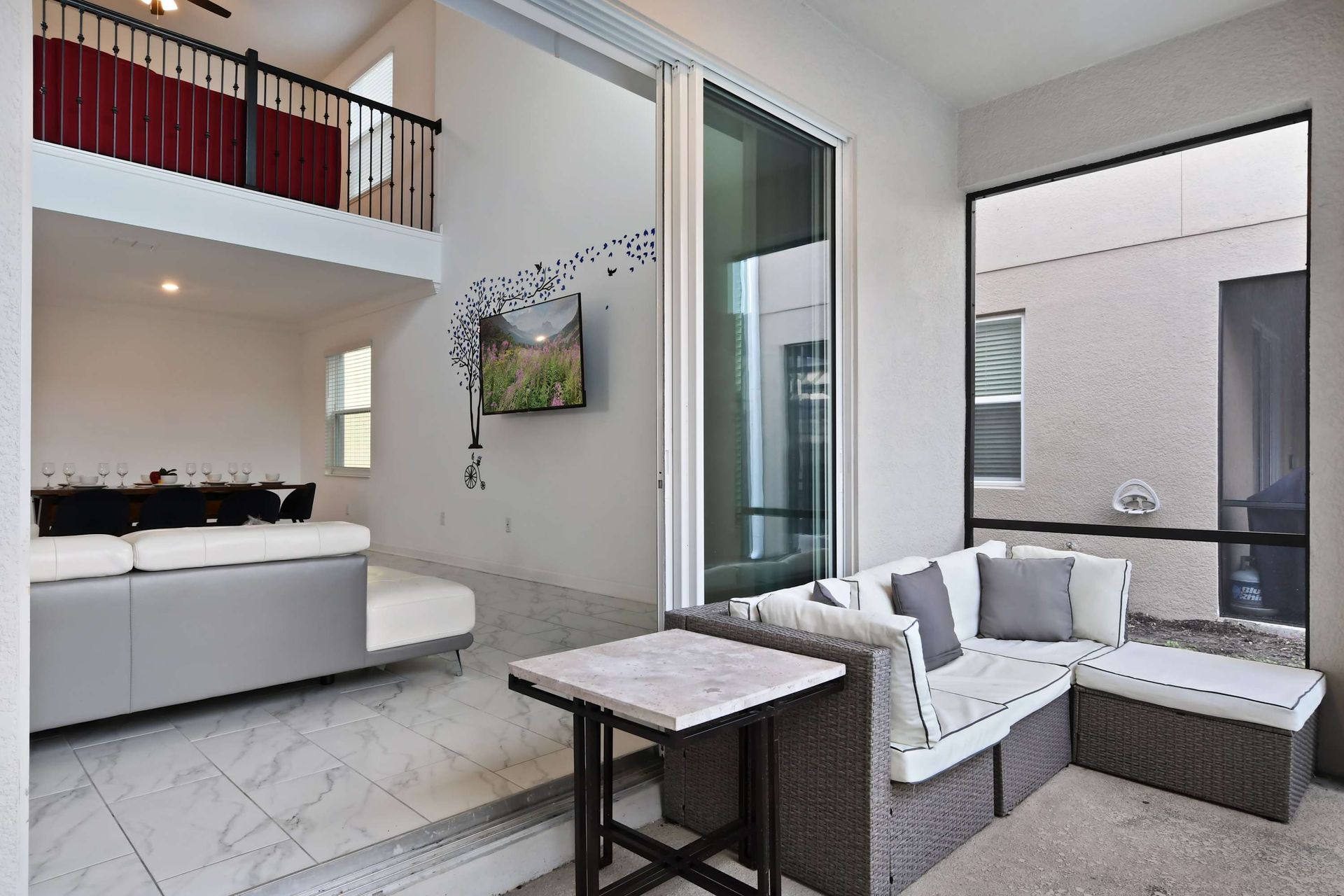 Seamless indoor-outdoor living with a cozy patio lounge and stylish interiors.