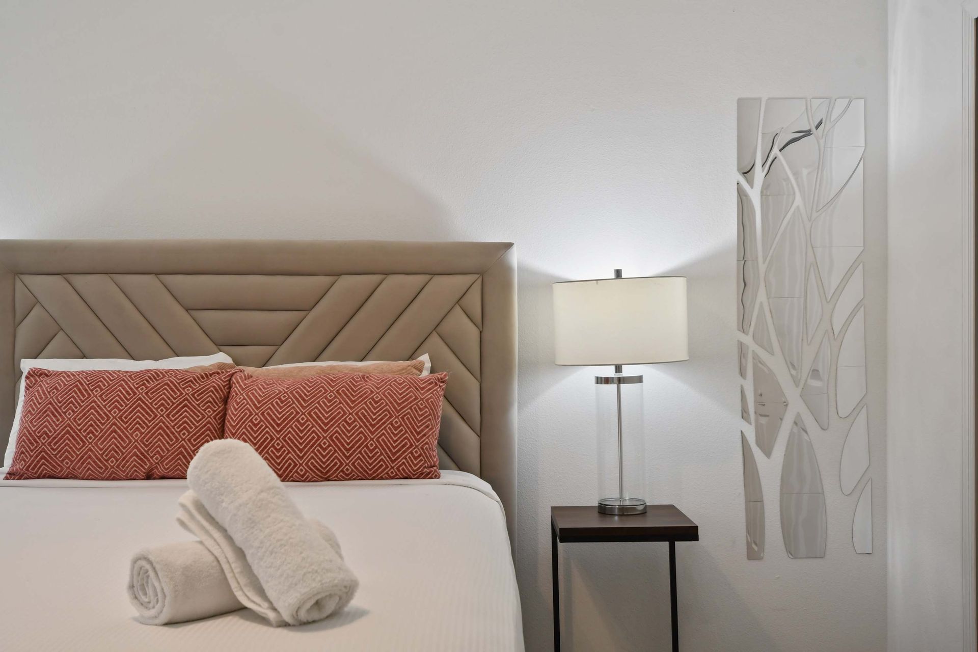 Cozy up in this chic bedroom with luxe linens, soft lighting, and modern decor.