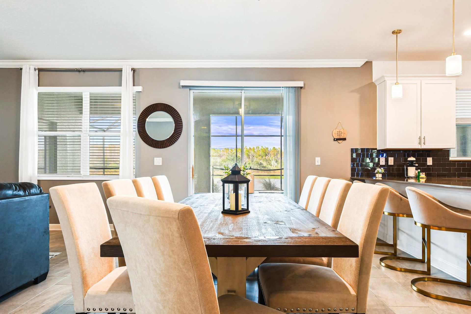 Spacious dining area with seating for 10 and scenic poolside views beyond.