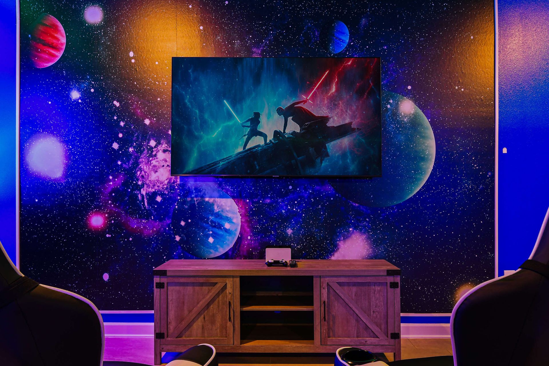 Epic space-themed media zone with gaming setup, theater seats, and galactic backdrop.