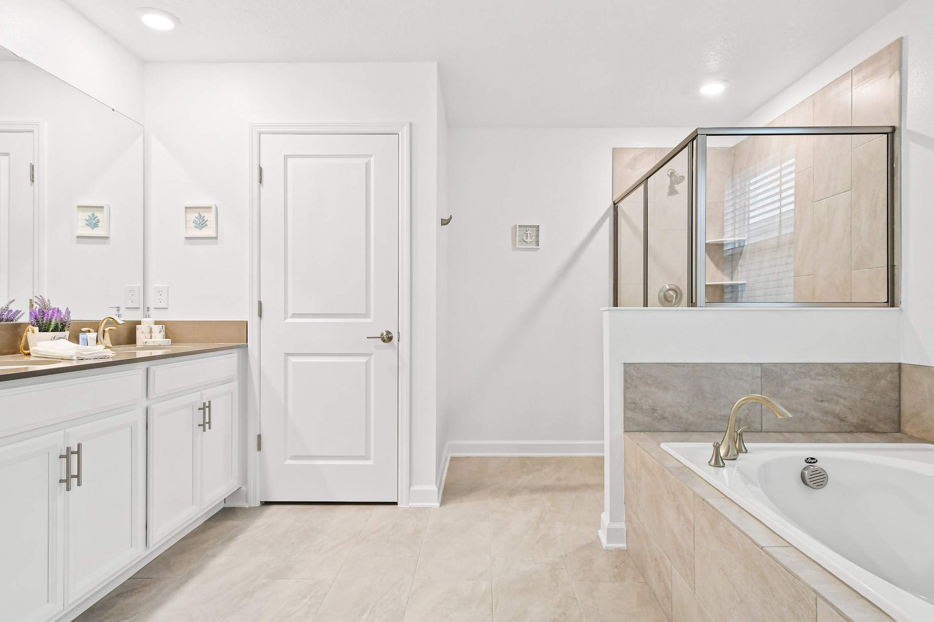 Luxurious master bath with soaking tub, glass shower, dual vanities, and spa vibes.