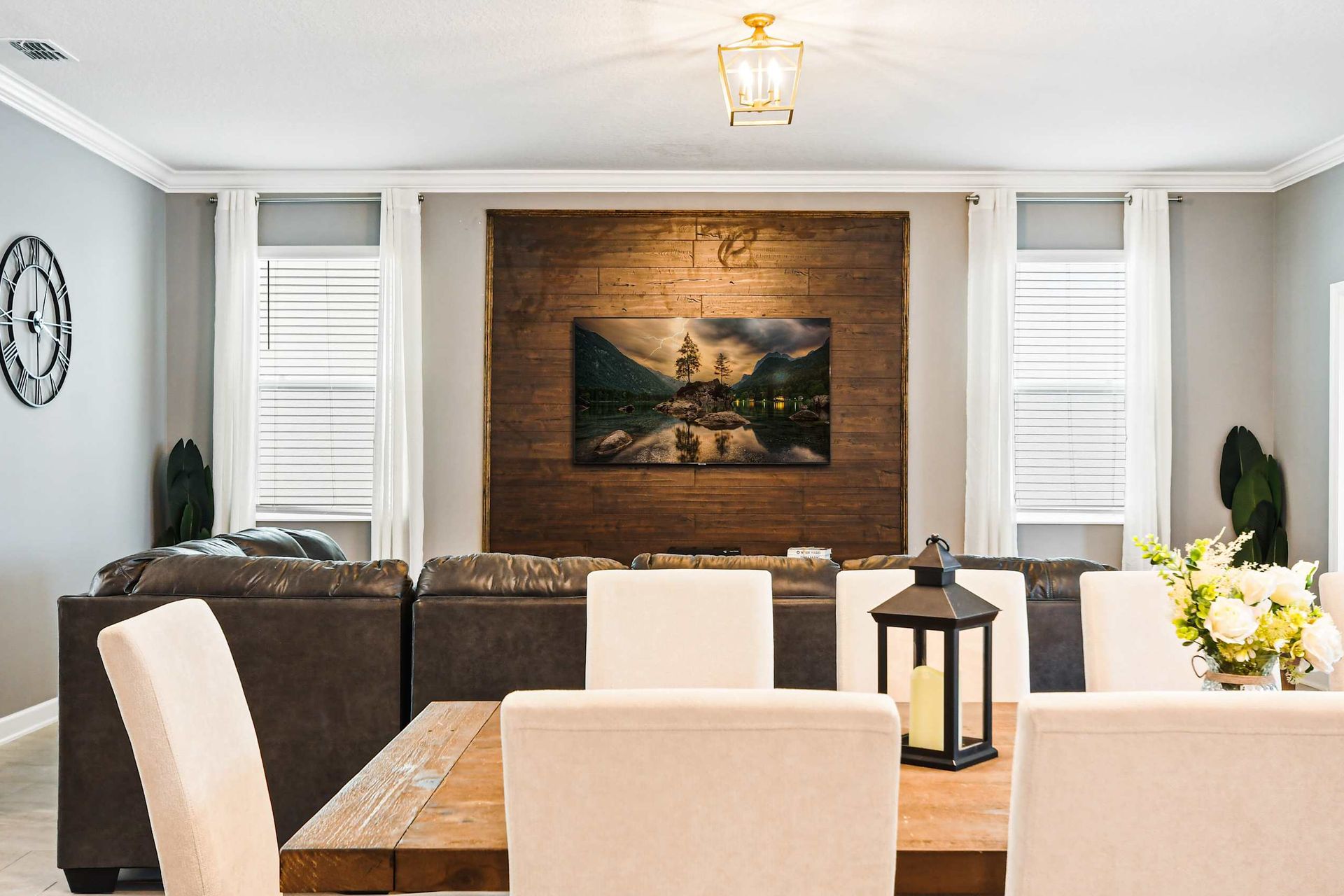 Stylish open-concept living with plush seating, wood accents, and natural light.