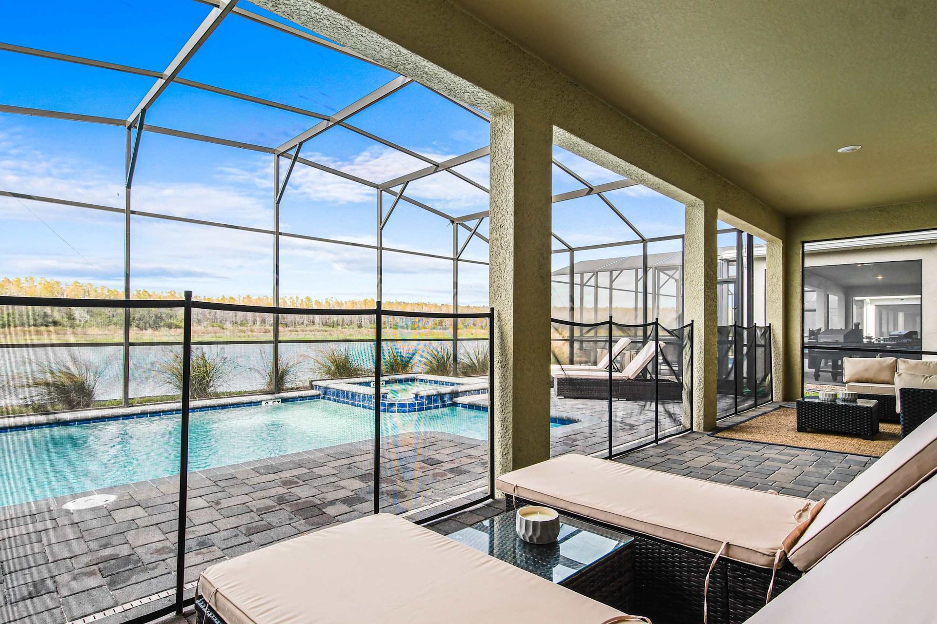 Lakeview lanai with private pool, spa, lounge seating, and serene screened patio.