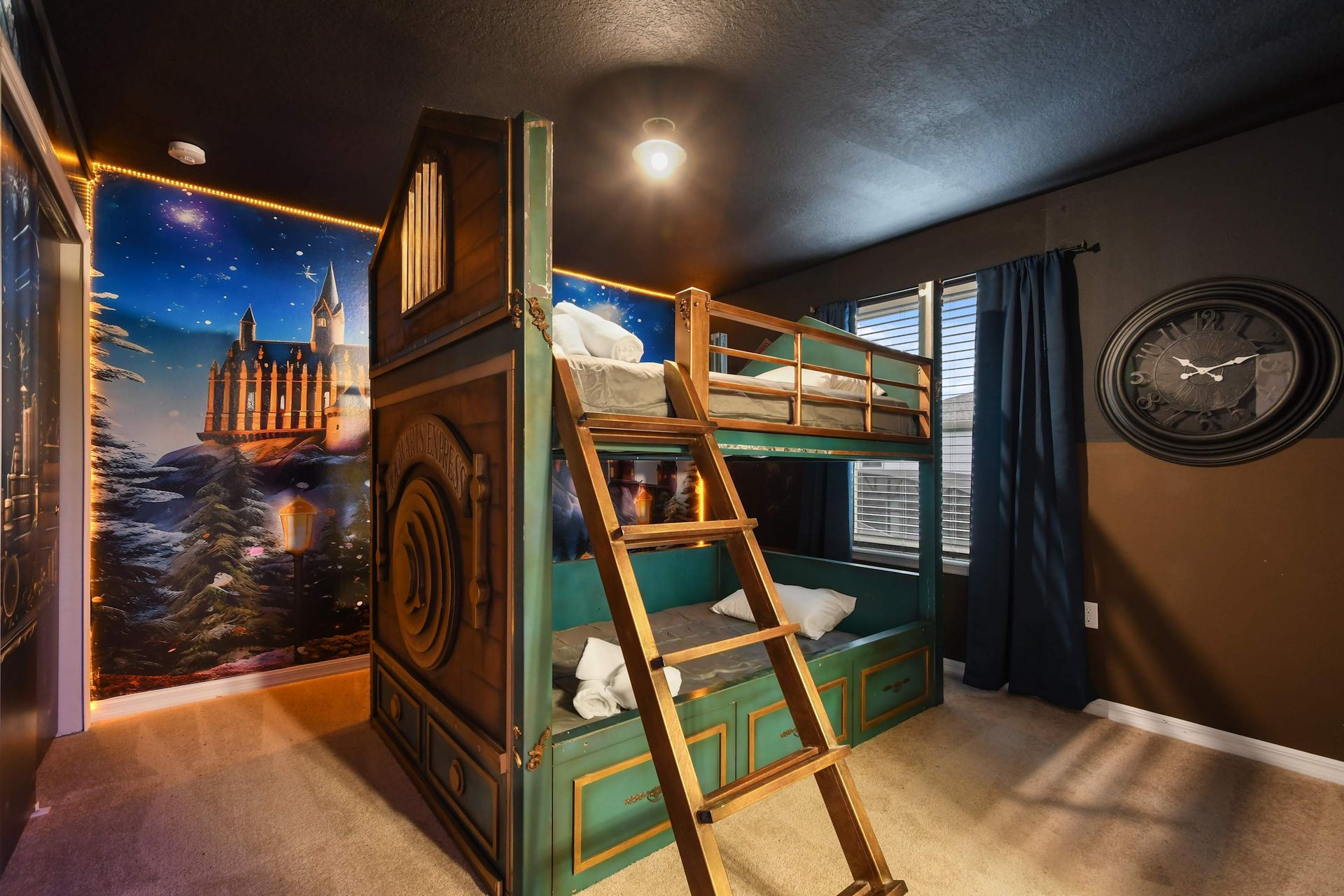 Magical train-themed bunk room with castle mural, perfect for young wizards!
