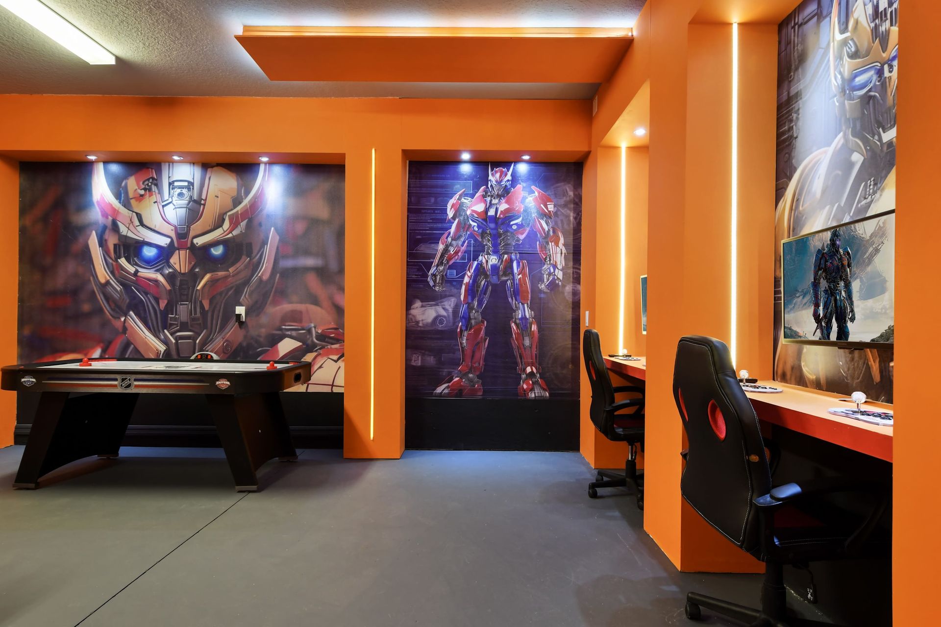 Immersive sci-fi gaming station with themed PCs, LED lighting, and pro chairs.
