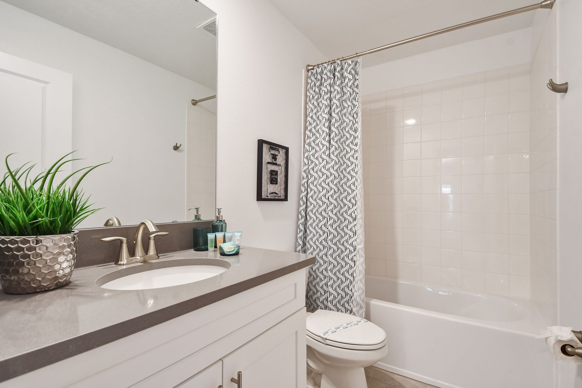 Fresh and functional full bath with tub/shower combo and modern vanity design.