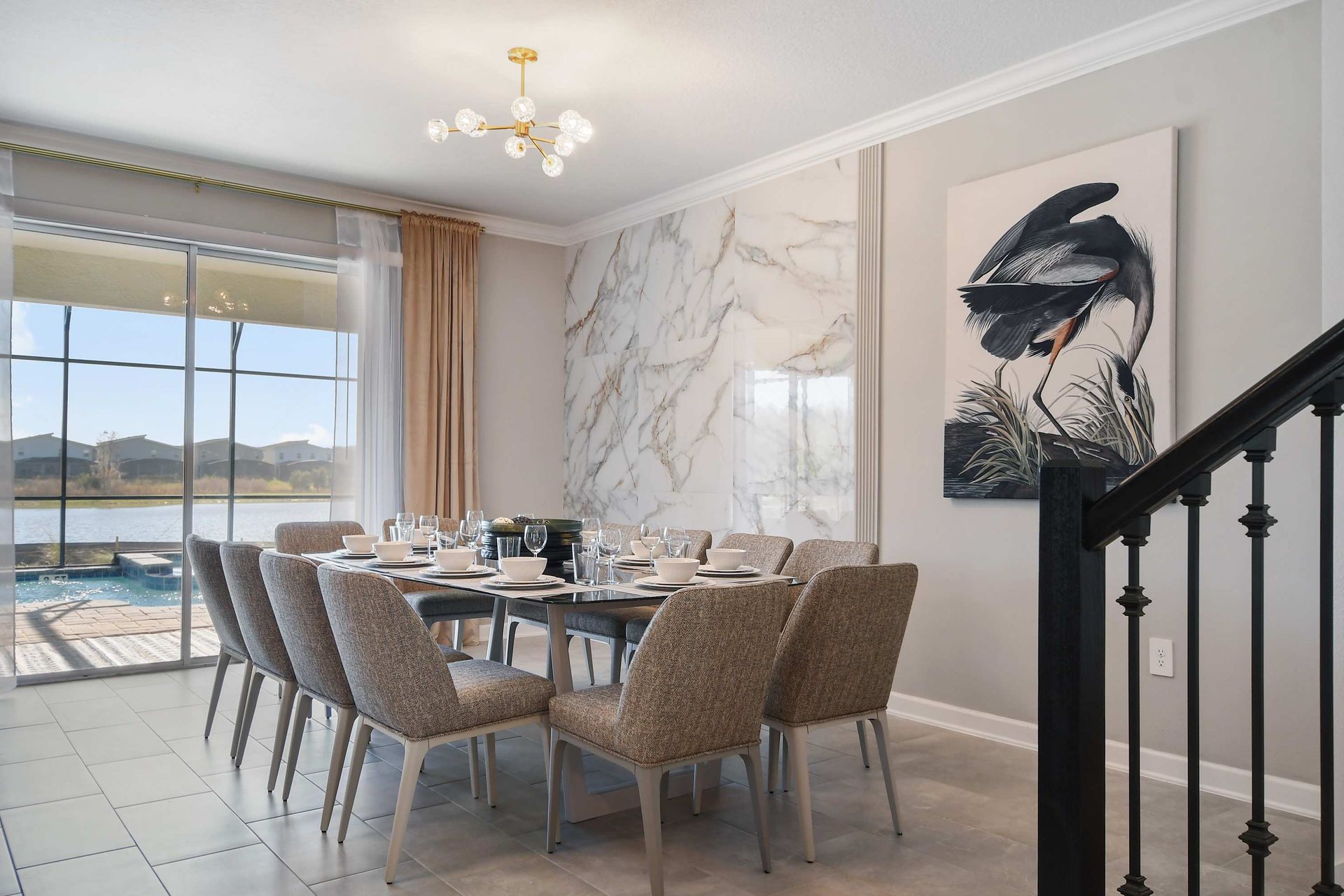 Elegant dining space with marble accent wall and lake views for memorable meals.
