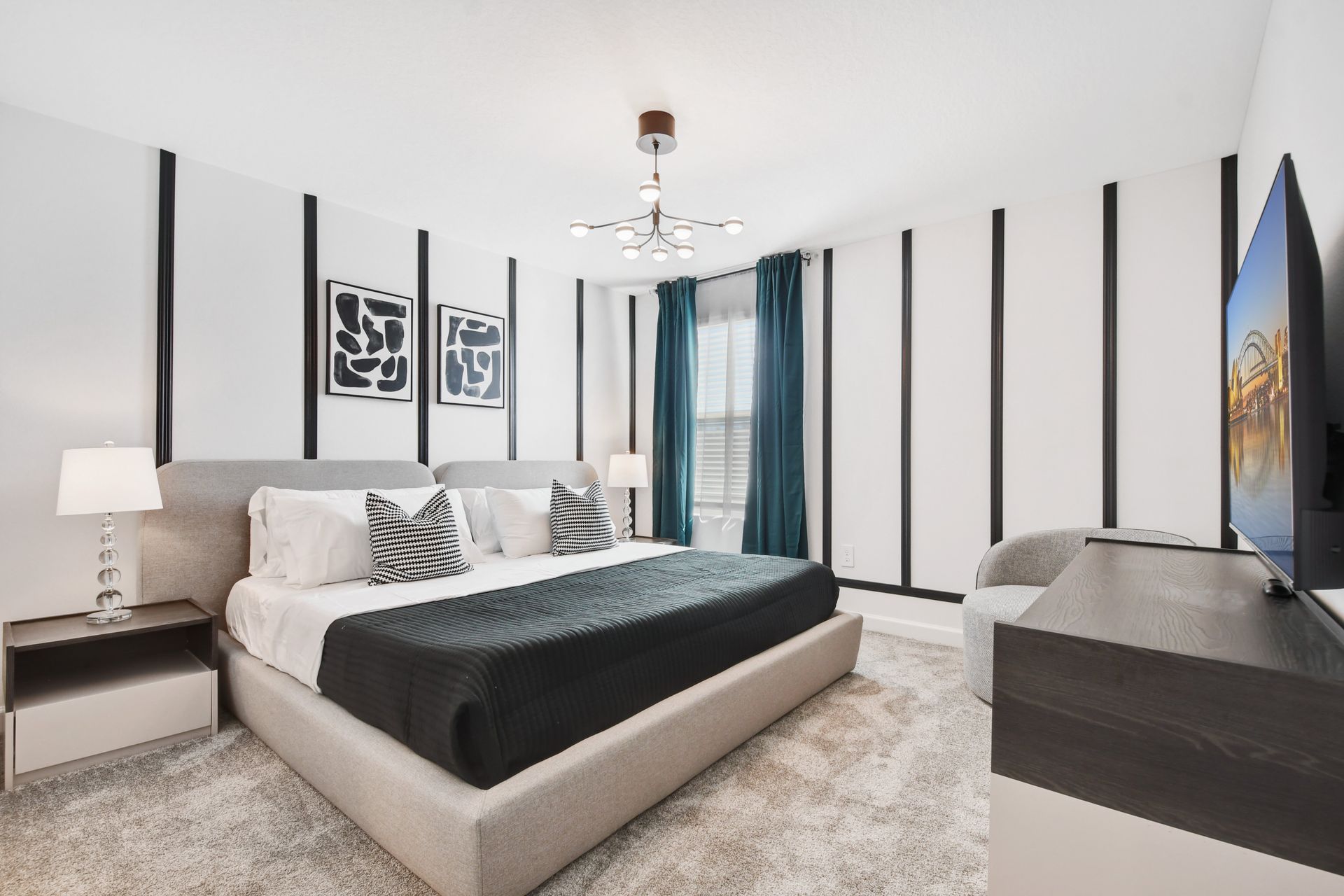 Modern king suite with bold accents, luxe bedding, and a smart TV for relaxing.