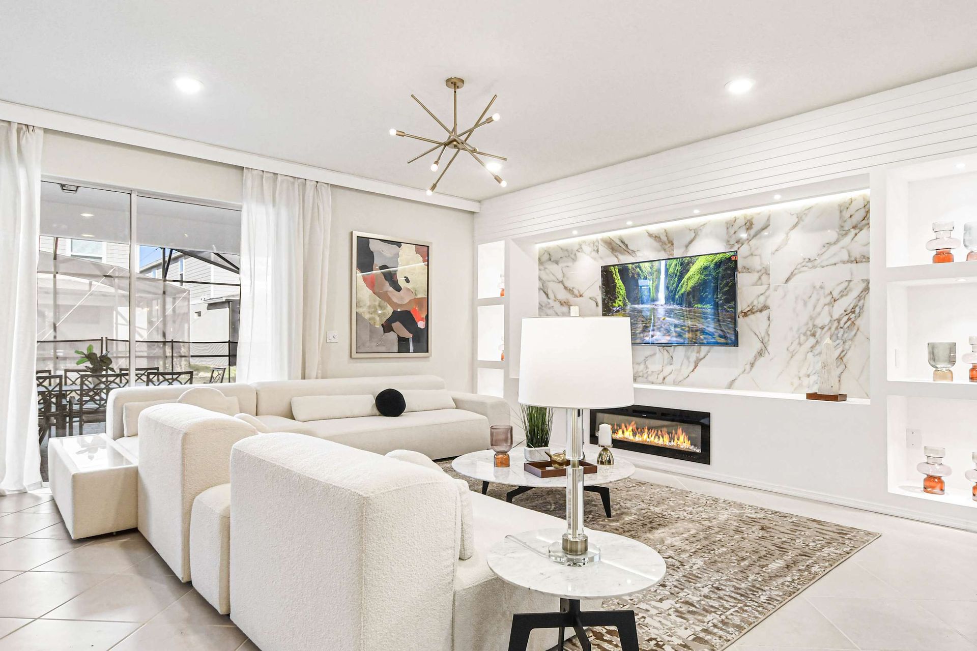 Chic modern living room with marble accents, cozy fireplace, and luxe seating