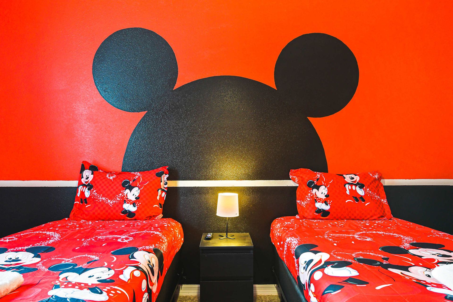 Vibrant Mickey-themed bedroom with twin beds, bold design, and playful energy