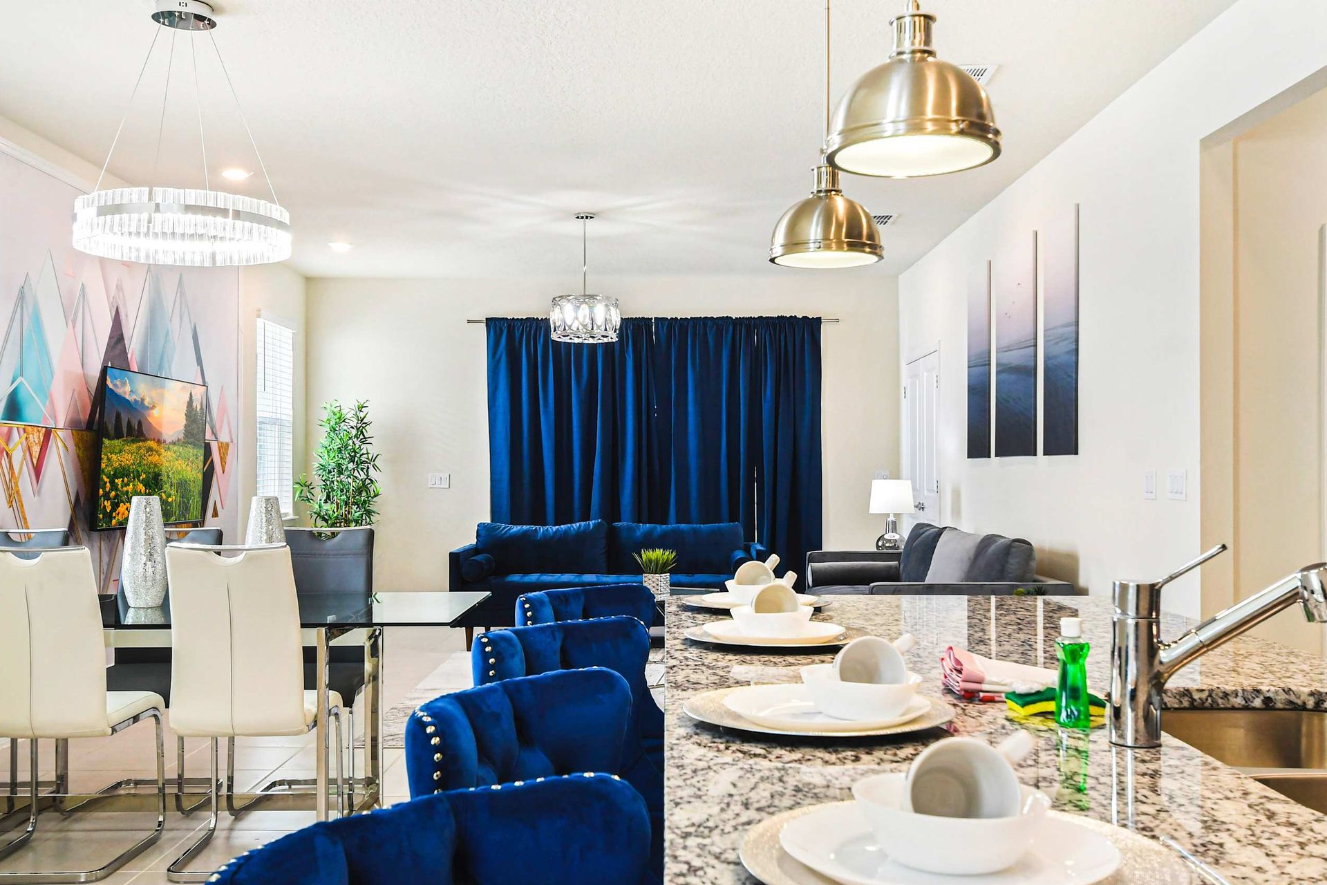 Bright, modern space with luxe seating, sleek kitchen, and elegant dining area