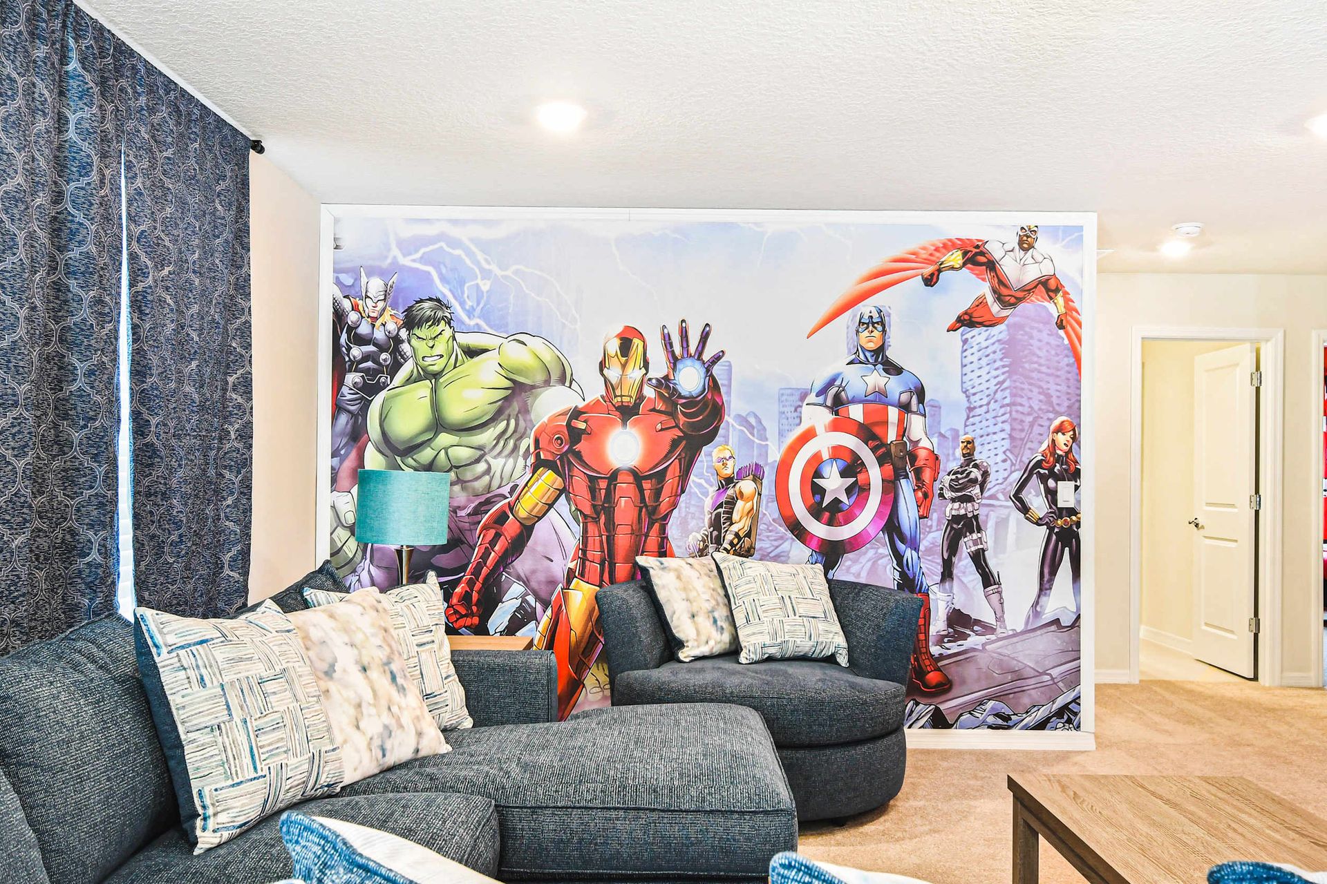 Hero-themed lounge with bold wall mural, cozy seating, and fun family vibes
