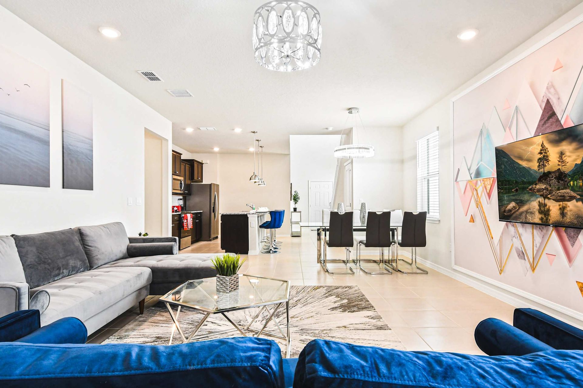 Stylish open-concept retreat with modern decor, full kitchen, and smart TV