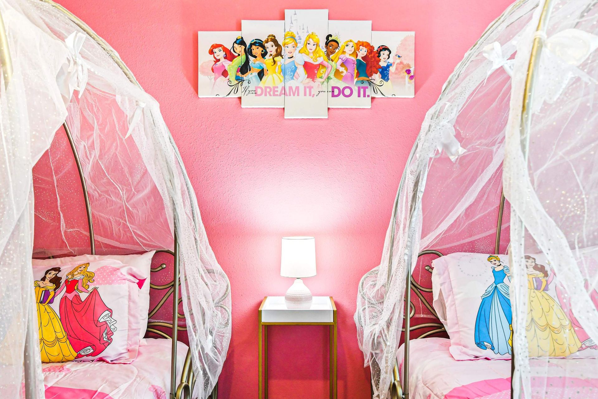 Charming princess room with canopy beds, pink decor, and fairytale touches