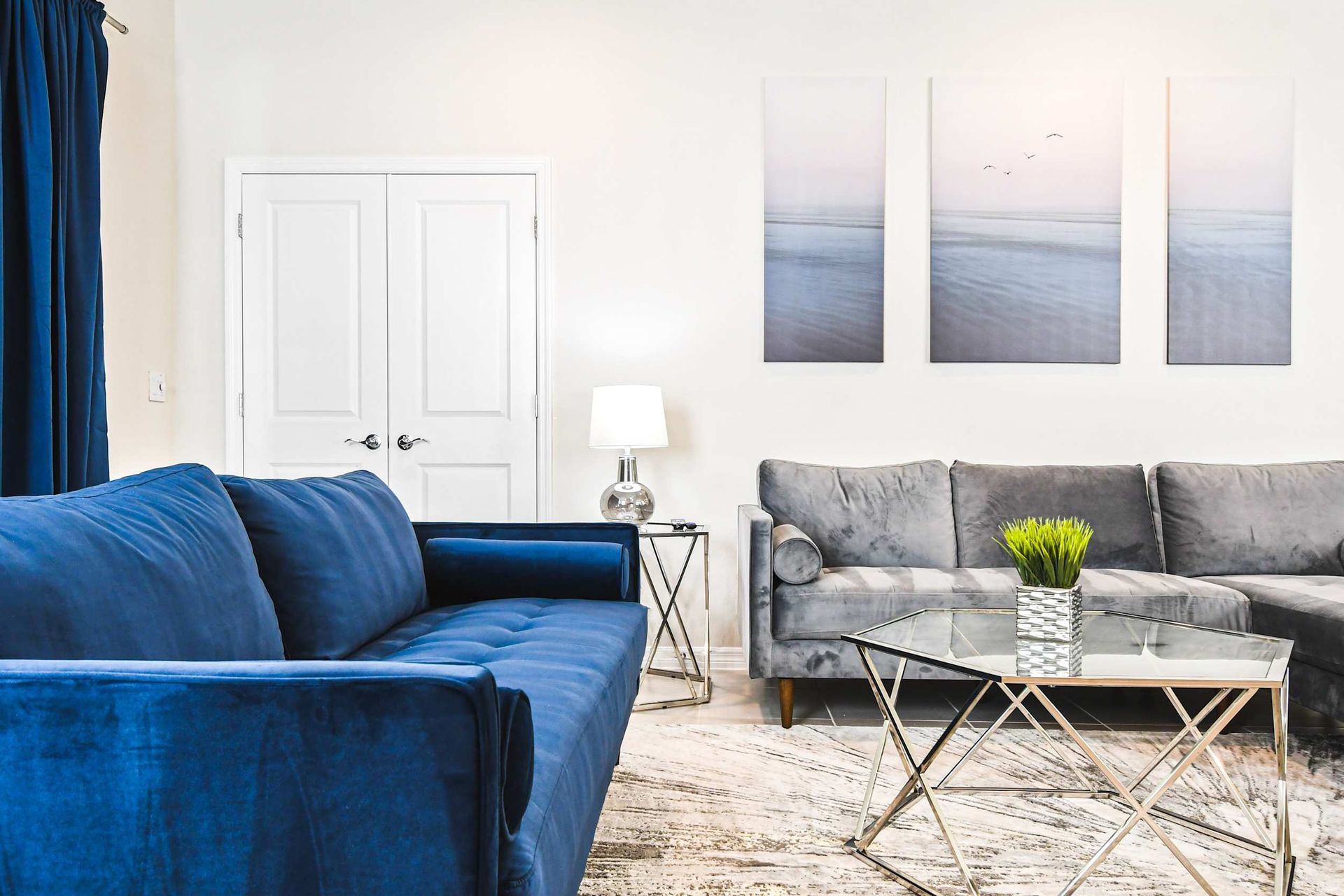 Elegant living area with velvet seating, modern art, and cozy ambient lighting