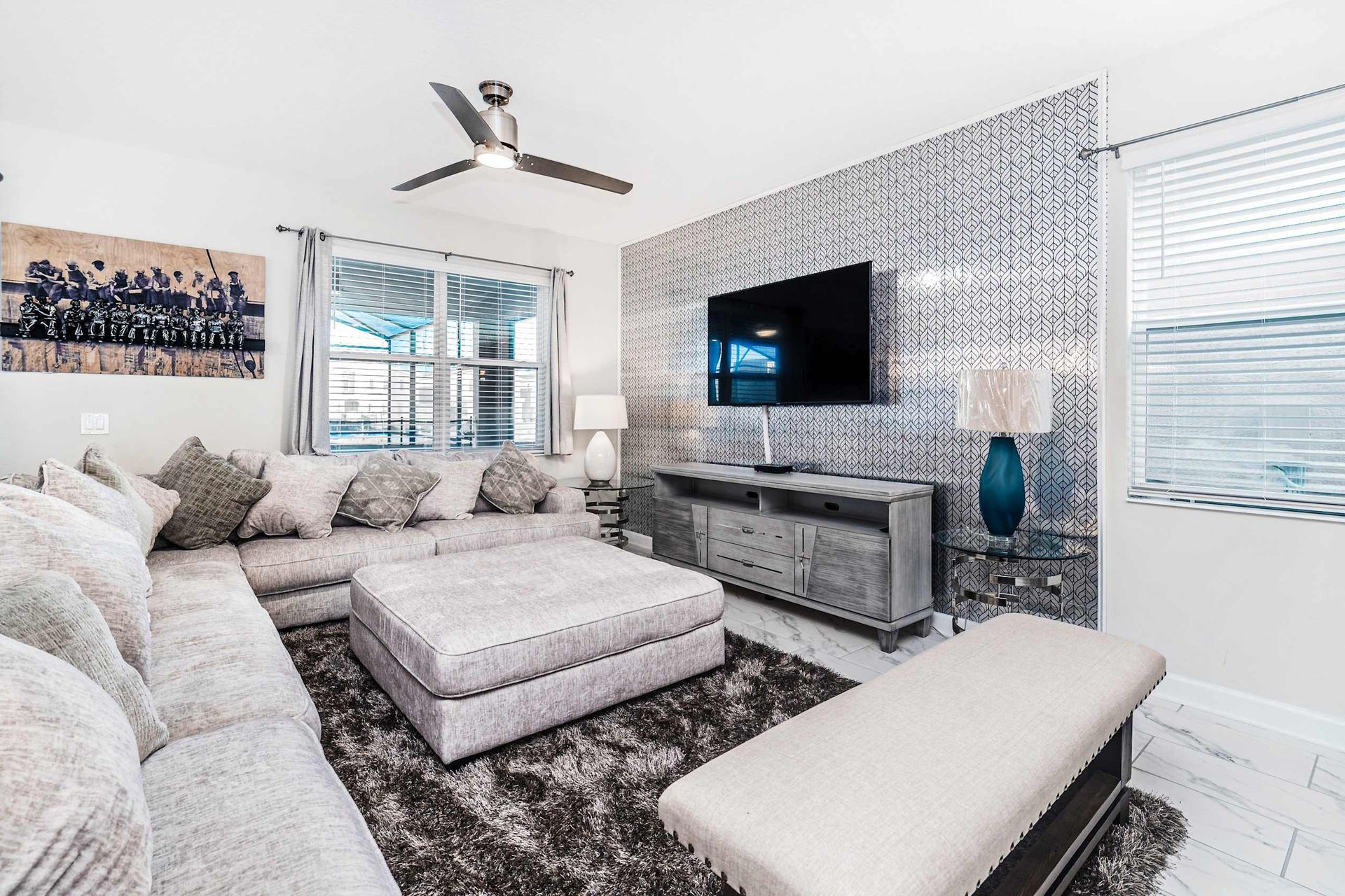 The expansive living room beckons with its generous space, adorned with a plush and inviting sofa, creating an ideal setting for cherished family reunions.