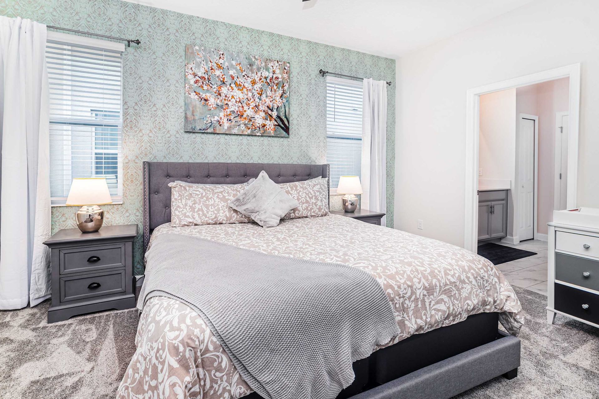 Experience the epitome of comfort in a cozy bedroom, where plush textiles, subdued lighting, and tasteful decor converge to create a warm and inviting sanctuary.