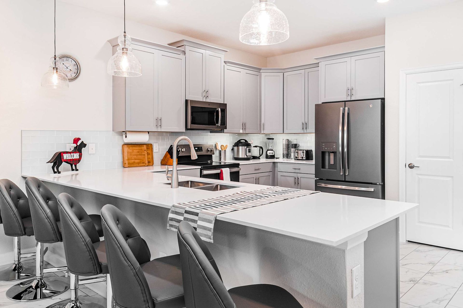Start your day in style at the sleek breakfast bar, a chic and casual space that adds a touch of modern elegance to your morning routine.