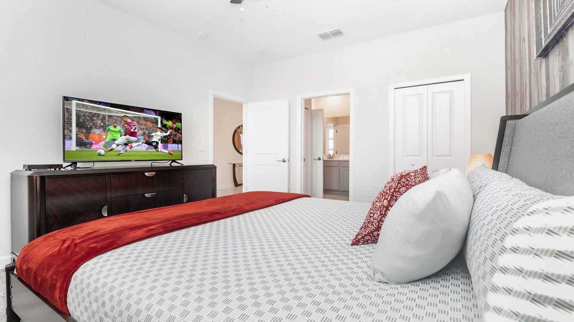 Chic bedroom with cozy bedding, ensuite bath, and a smart TV for unwinding.