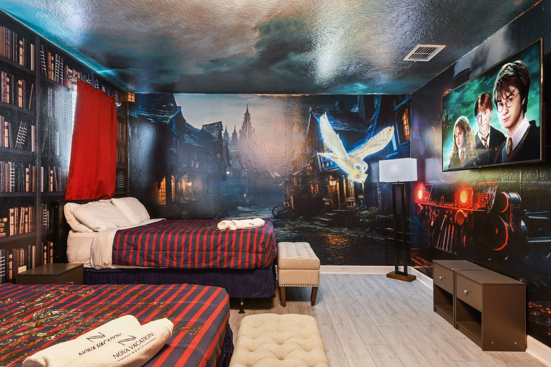 Magical train-themed room with bold murals, comfy beds, and a spellbinding vibe.
