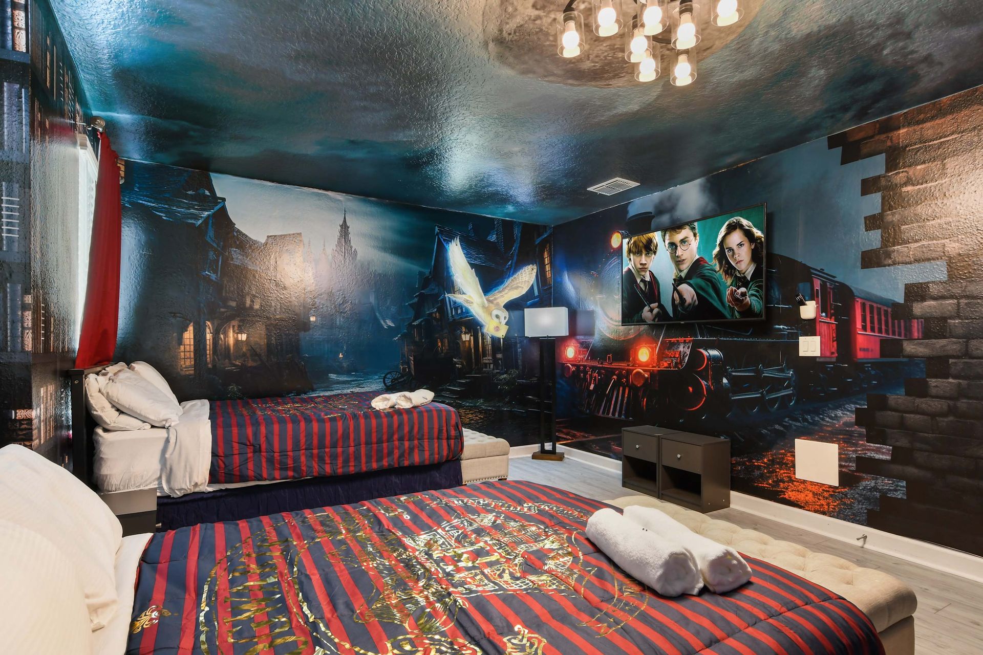 Magical train-themed room with bold murals, comfy beds, and a spellbinding vibe.