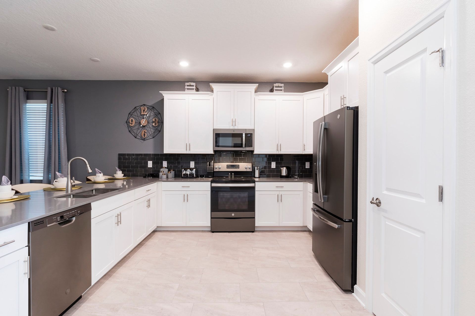 Cook up a storm in this fully equipped, modern kitchen with sleek countertops, stainless steel appliances, and a large island with a breakfast bar. Perfect for preparing family meals or quick snacks before heading out for the day!