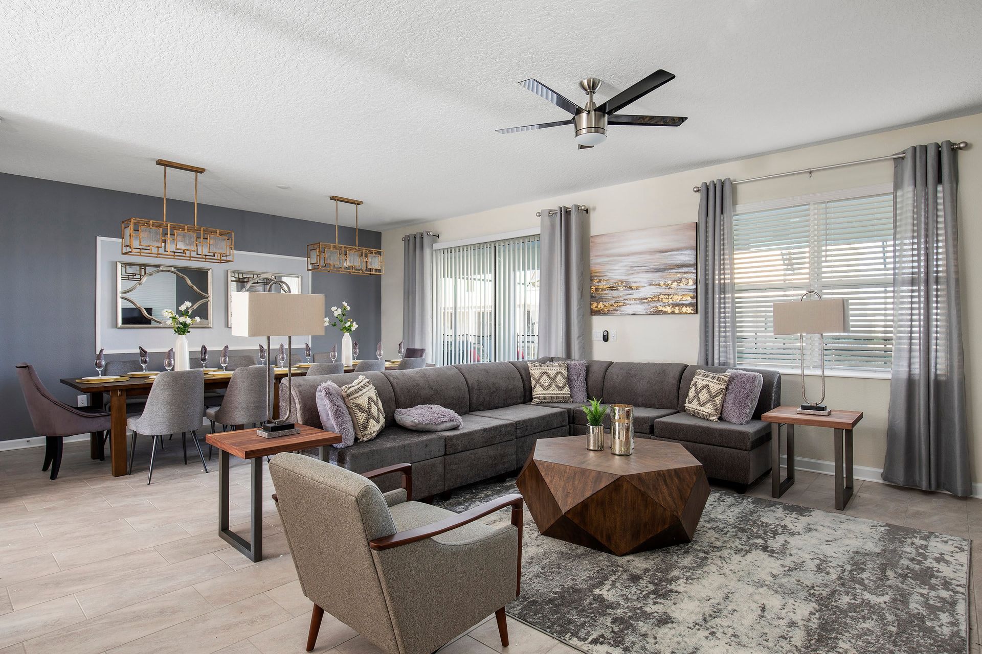 Step into the beautifully designed living room featuring plush sofas, contemporary furnishings, and a large smart TV—perfect for relaxing after a day at the theme parks.