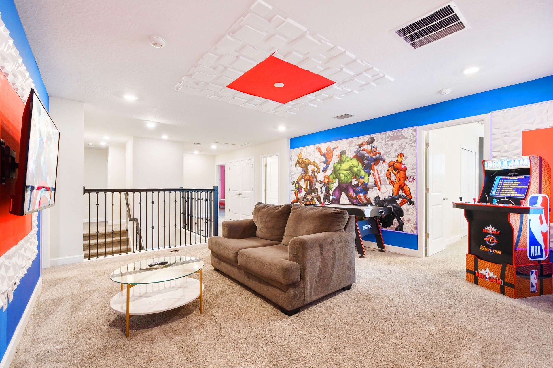 Superhero-themed game room with arcade, TV, and cozy seating!