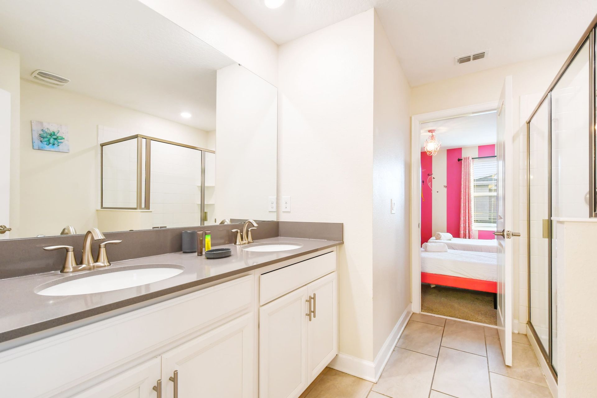 Modern bathroom with dual sinks, walk-in shower, and princess access!