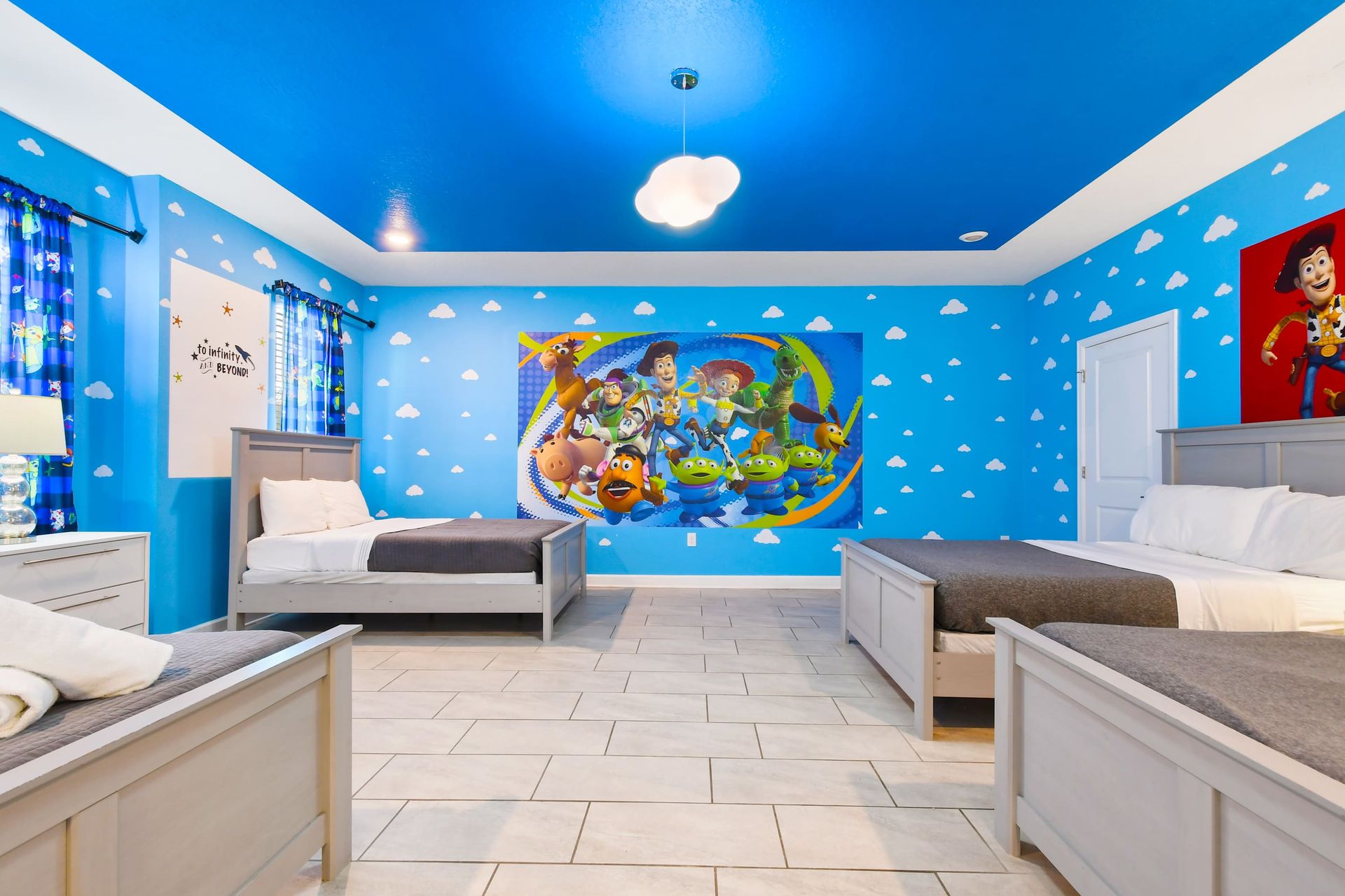 Vibrant Toy Story-themed bedroom with cloud-patterned walls.
