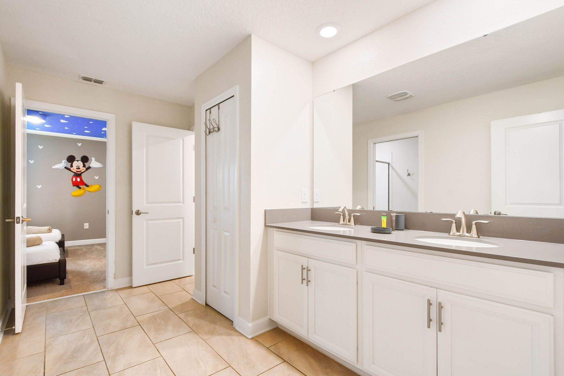 Bright bathroom with double sinks and access to themed bedroom!