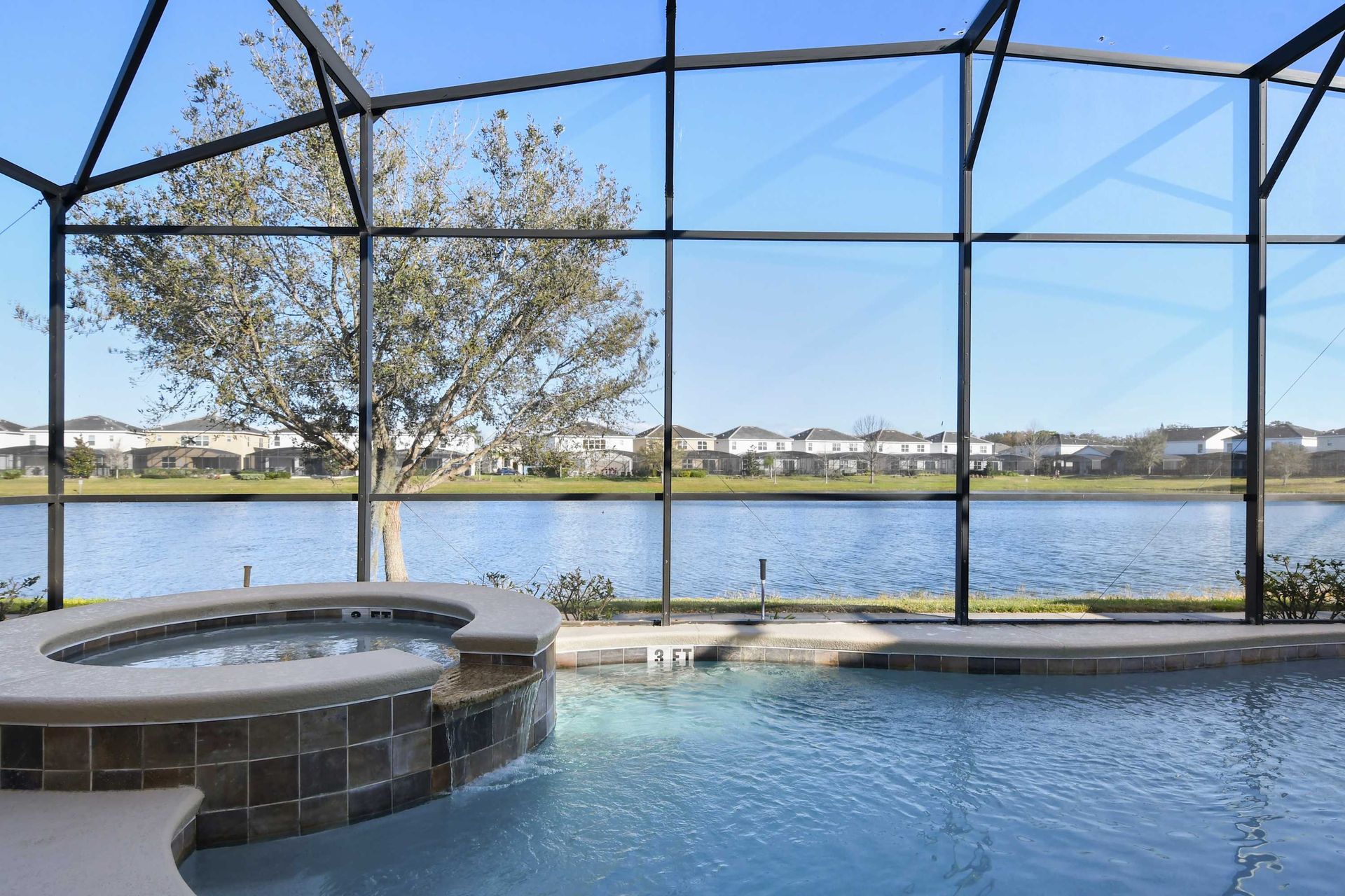 Relax by a screened pool & spa with serene lakefront views