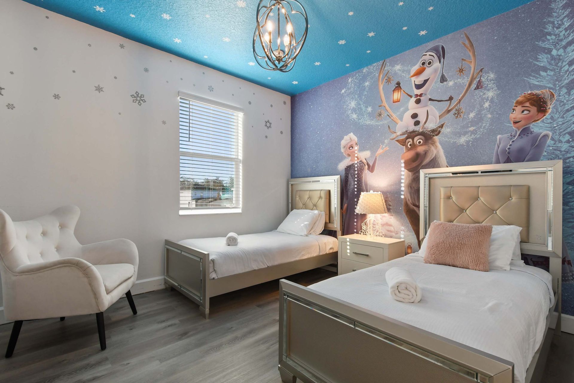 Whimsical kids' room with Frozen-themed decor and cozy twin beds