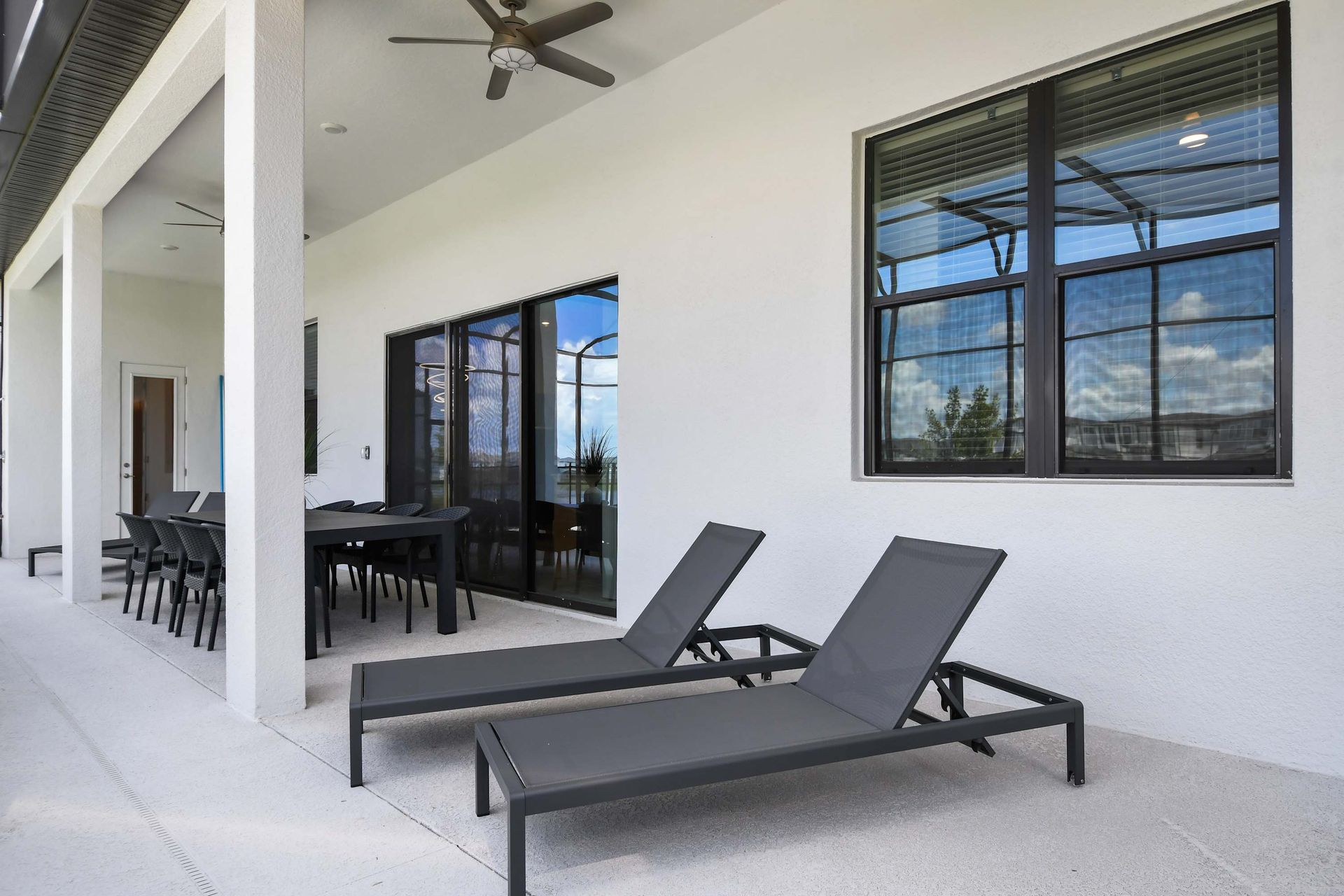 Relax in style with shaded dining, lounge chairs, and ceiling fans on the lanai.
