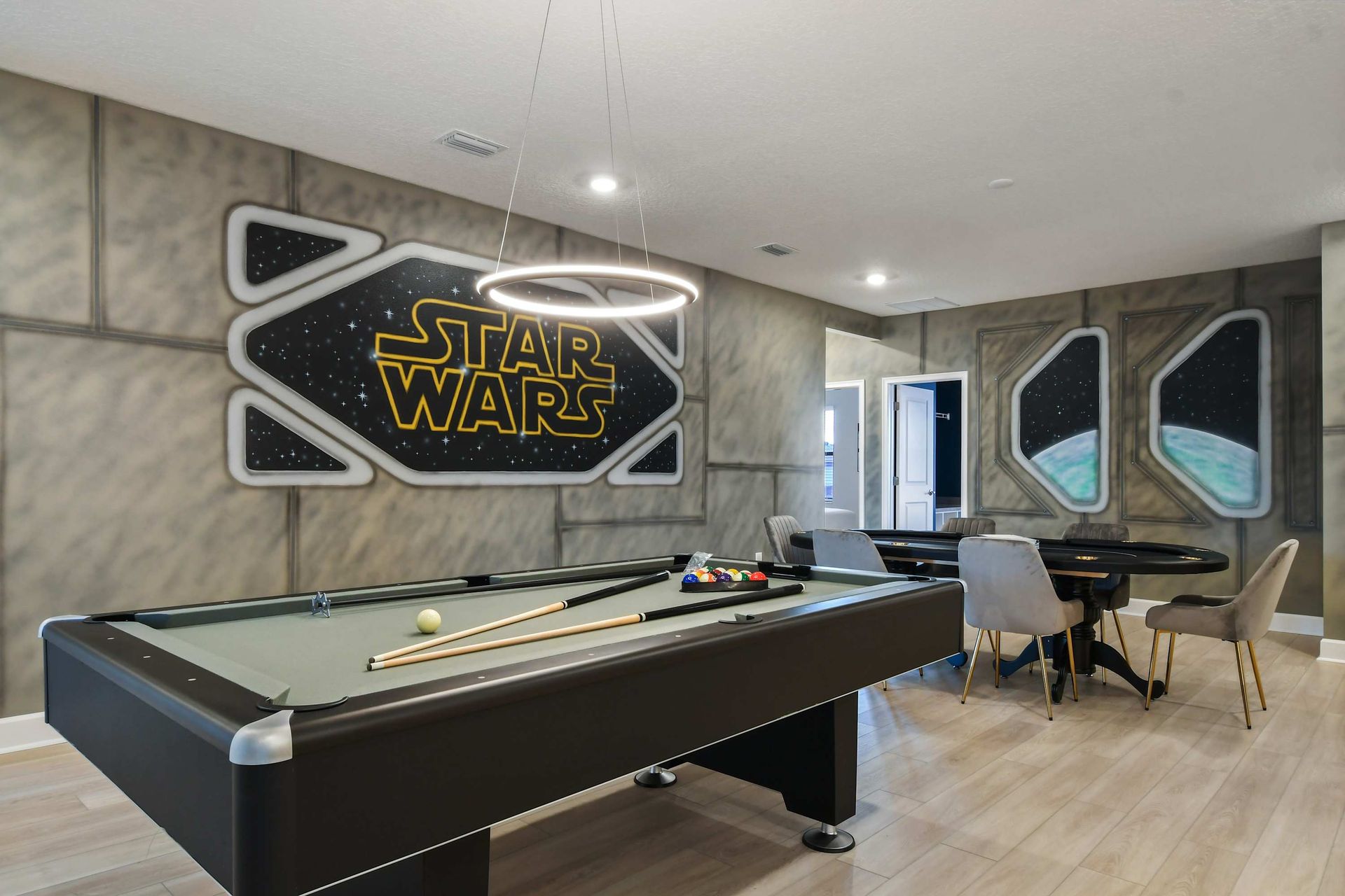 Epic Star Wars game room with pool table, poker setup, and intergalactic flair.