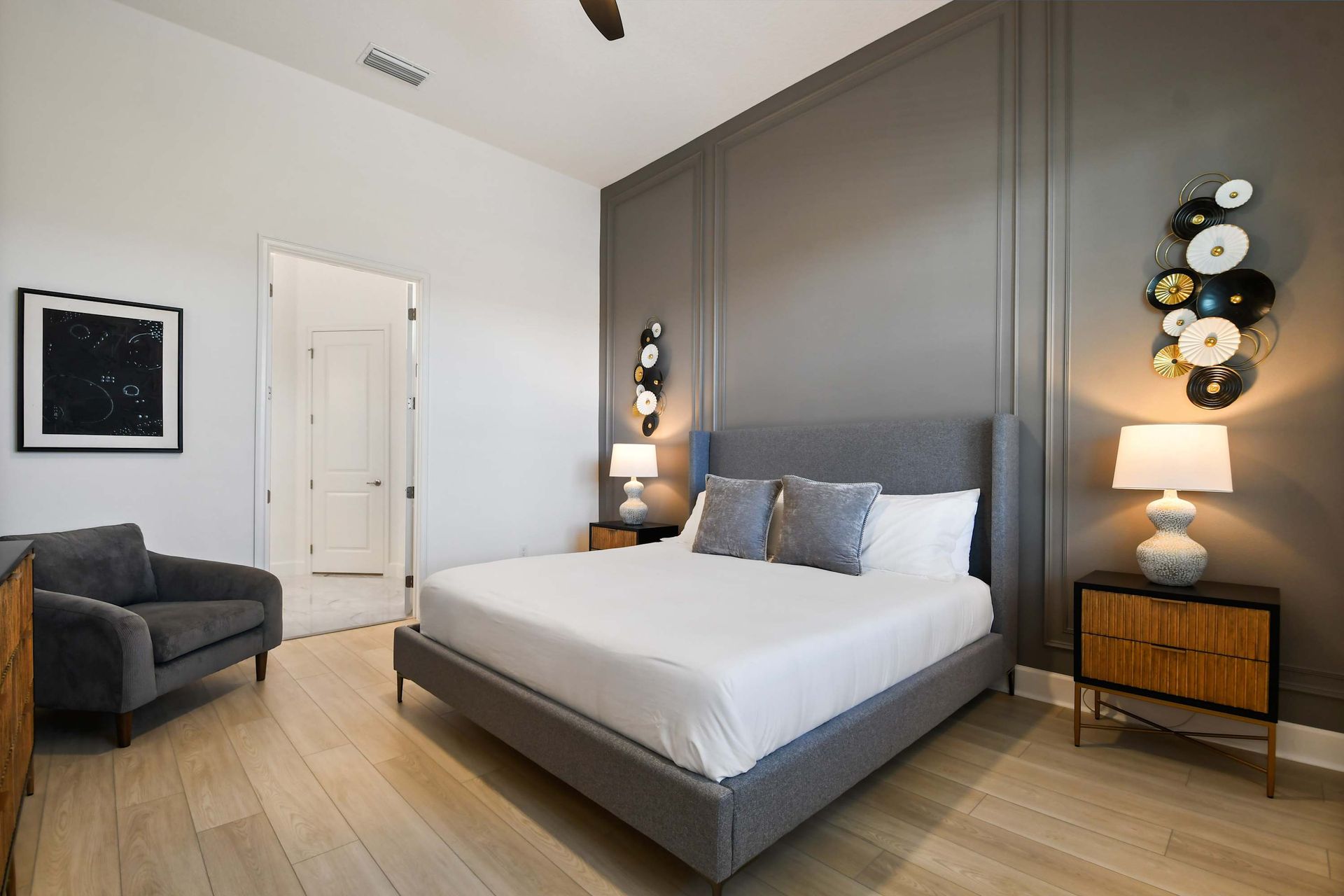 Elegant queen suite with bold accent wall, plush bedding, and a sleek modern vibe.