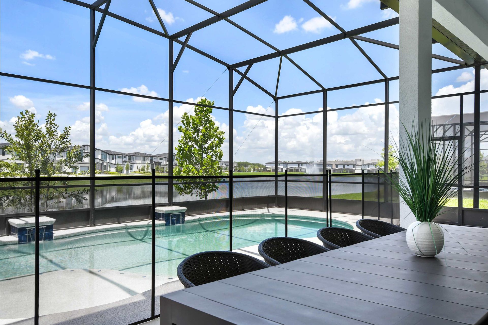 Dine poolside with tranquil lake views in this screened-in outdoor oasis.