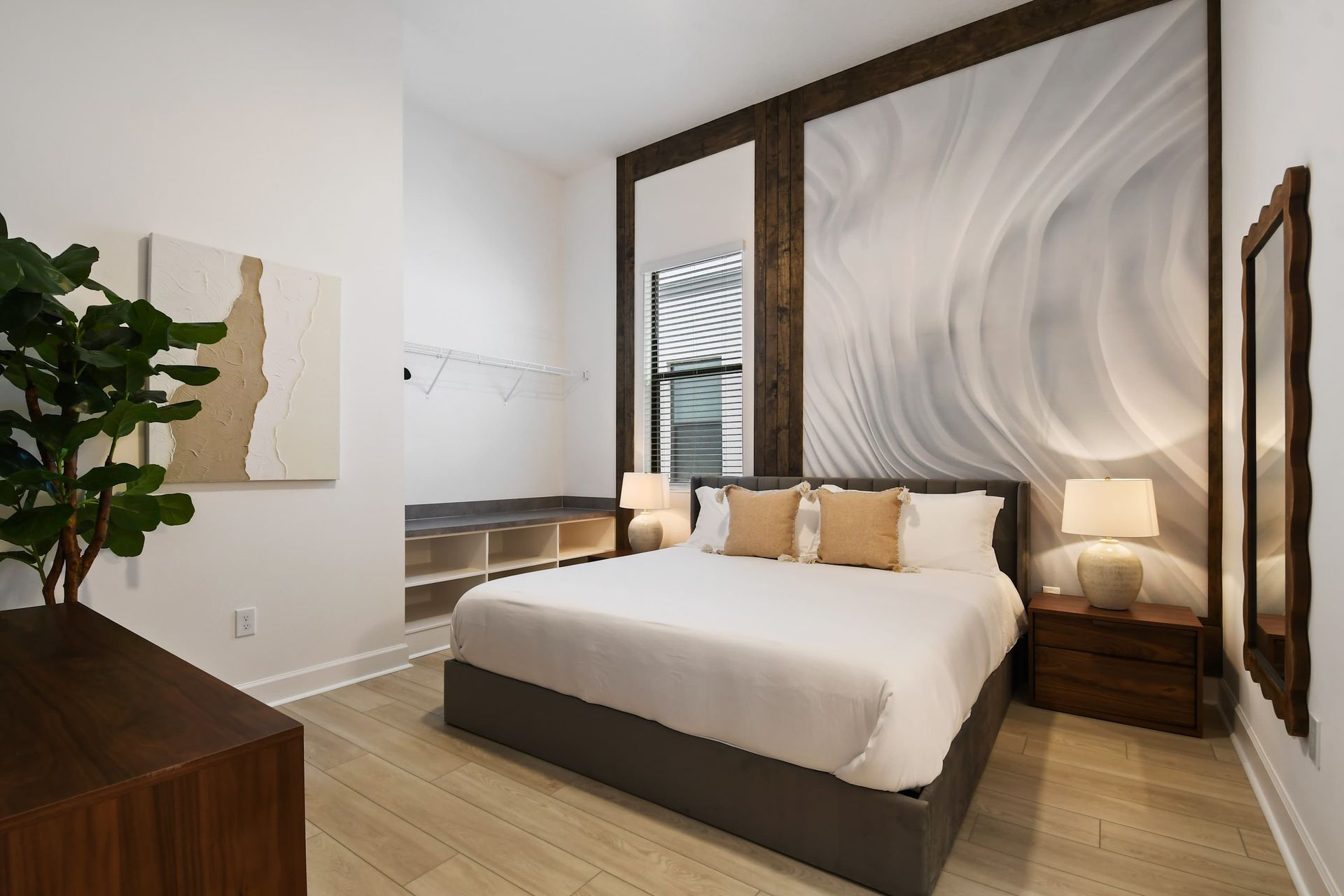 Calm and inviting king suite with modern textures and warm wood-accented charm.