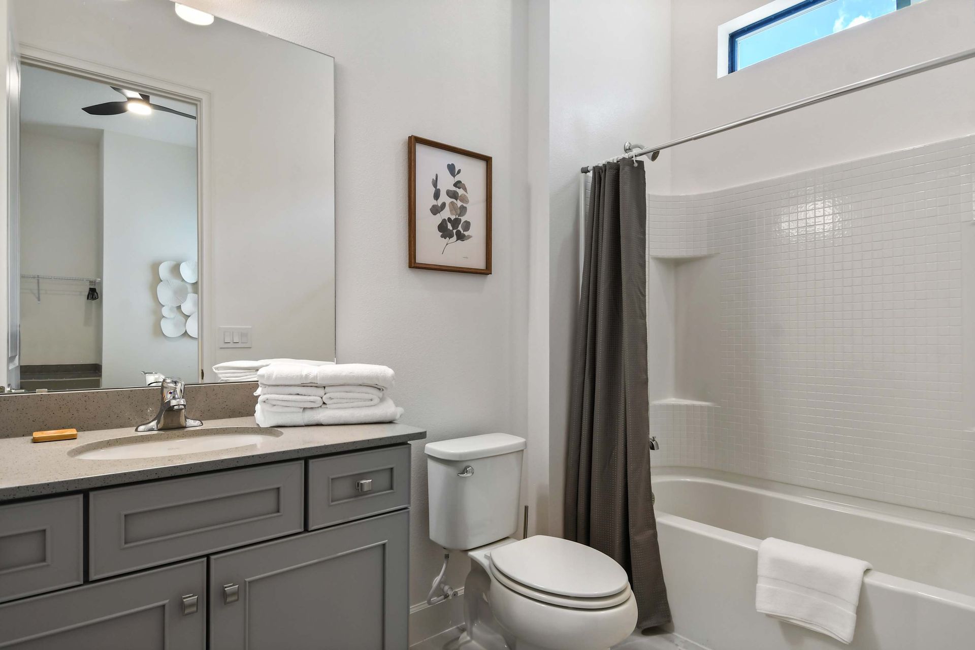 Bright and clean full bath with a soaking tub, soft lighting, and modern touches.