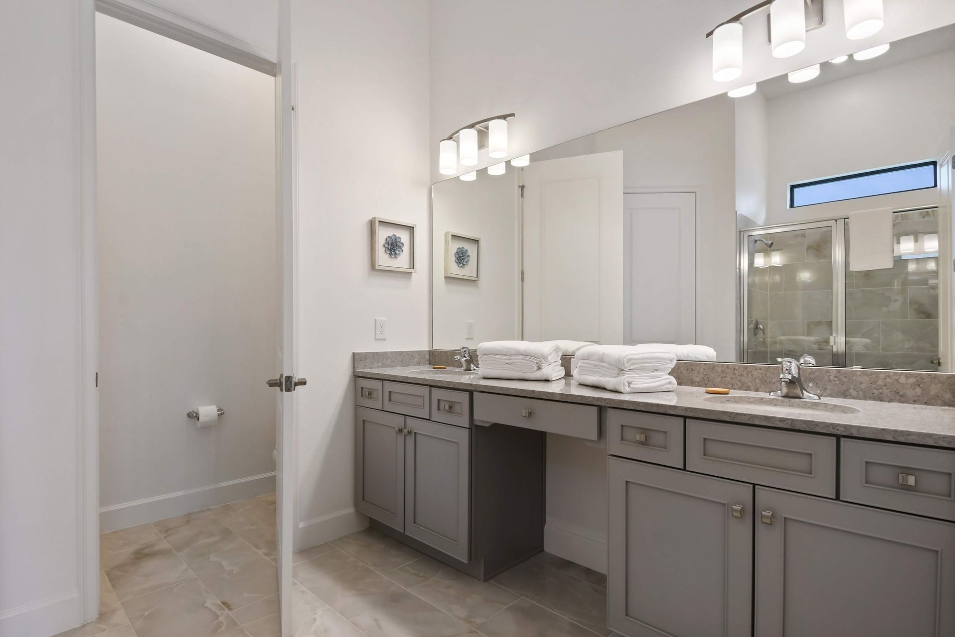 Stylish bathroom with double sinks, spacious vanity, and a sleek walk-in shower.