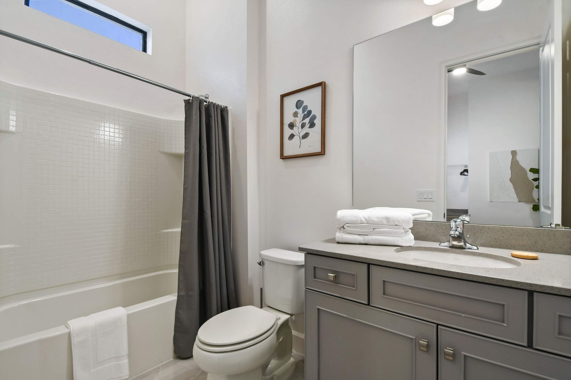 Serene full bath with a modern vanity, soft tones, and relaxing natural light.