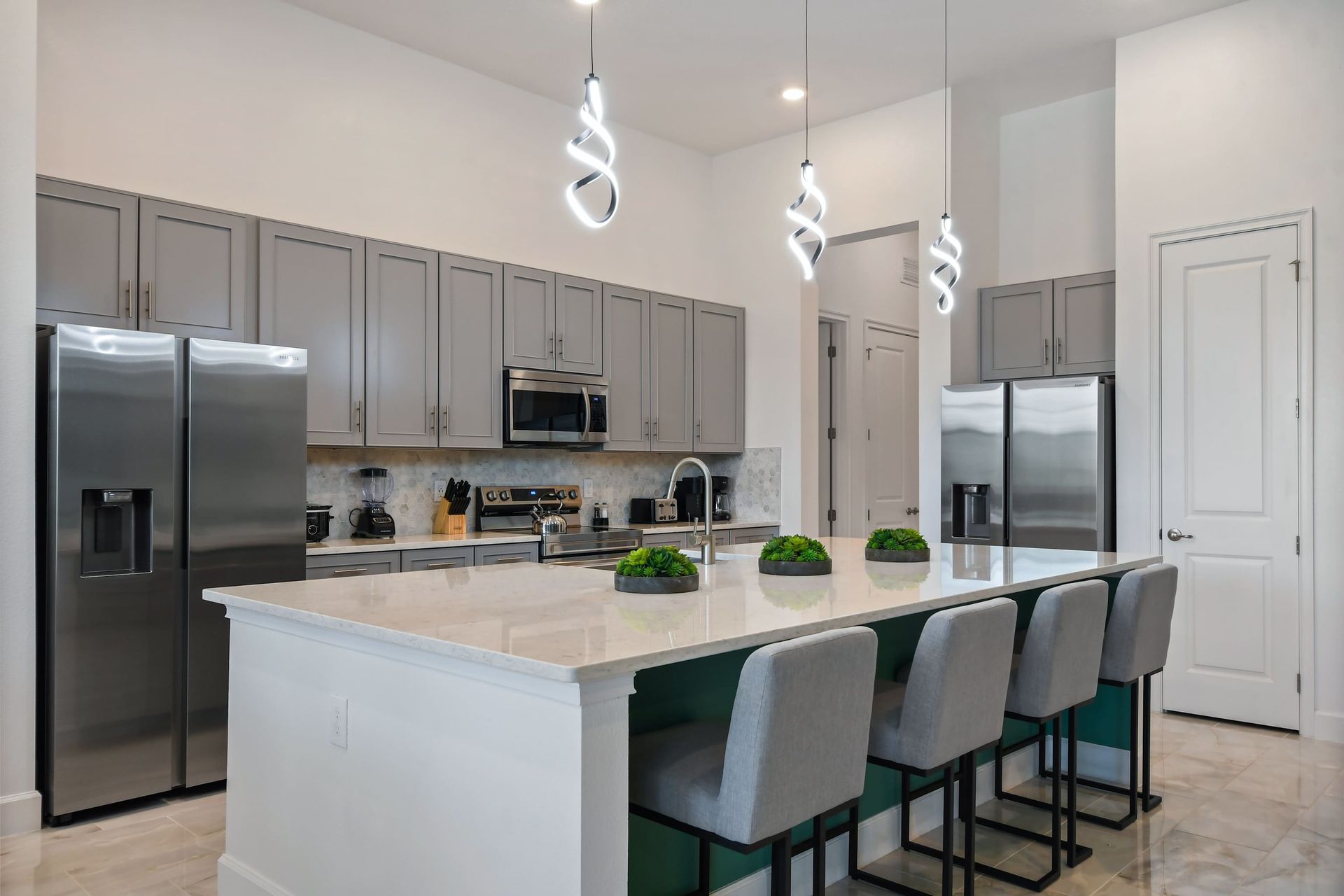Prepare gourmet meals in the fully equipped modern kitchen, complete with two refrigerators, an oven, microwave, dishwasher, and ample counter space.