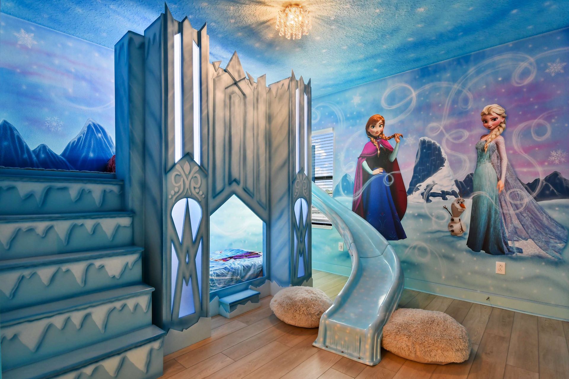 Frozen-themed wonderland with castle bunk, icy slide, and magical wall mural.
