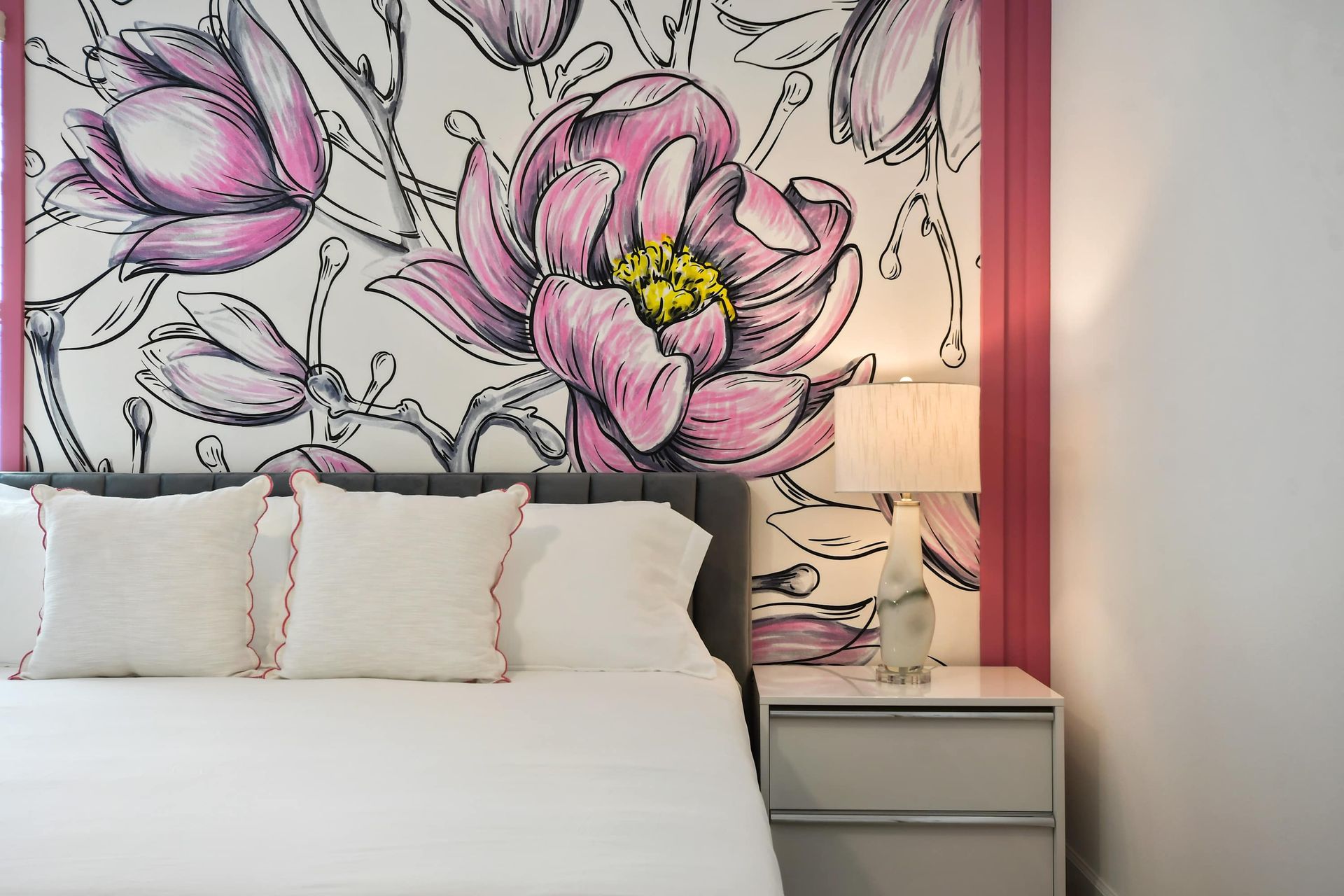 Floral feature wall and plush king bed make this suite a stylish retreat.