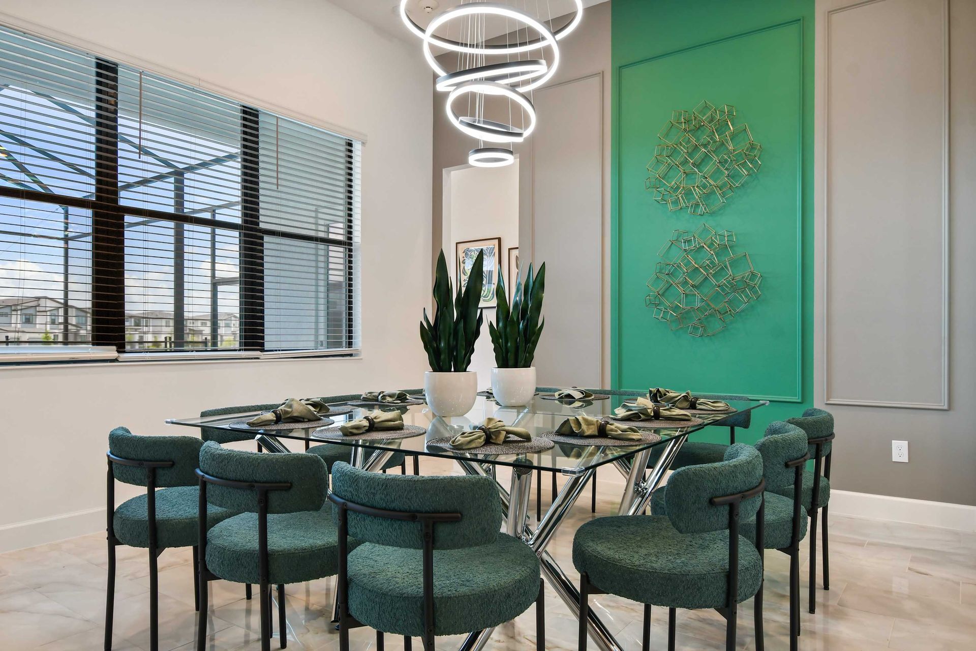 Elegant dining room with modern decor, glass table, and stunning light fixture.