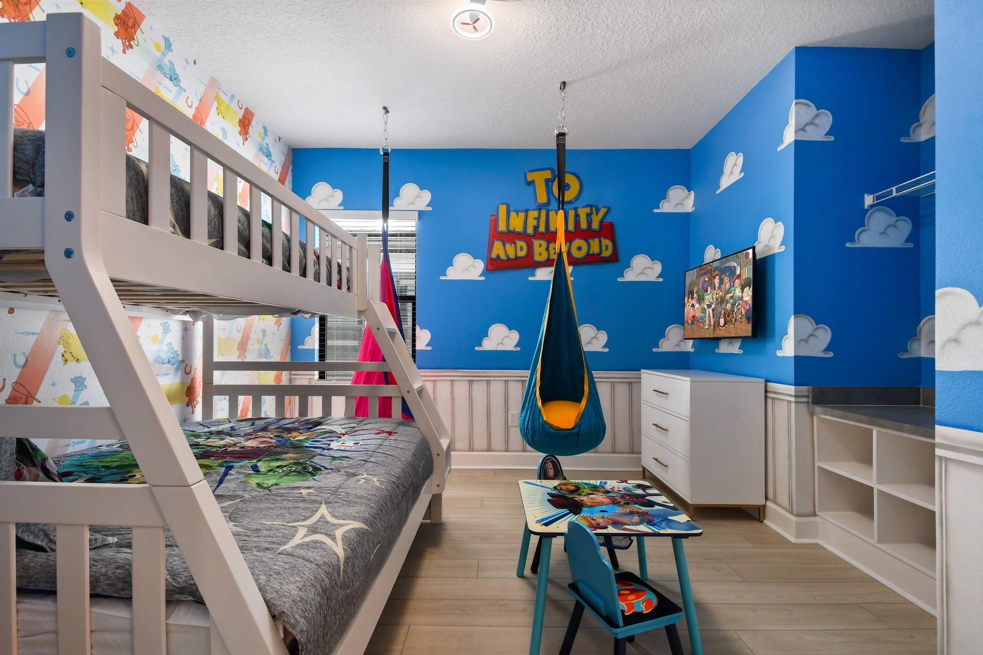 Toy Story-themed bunk room with swings, TV, and fun for infinity and beyond.